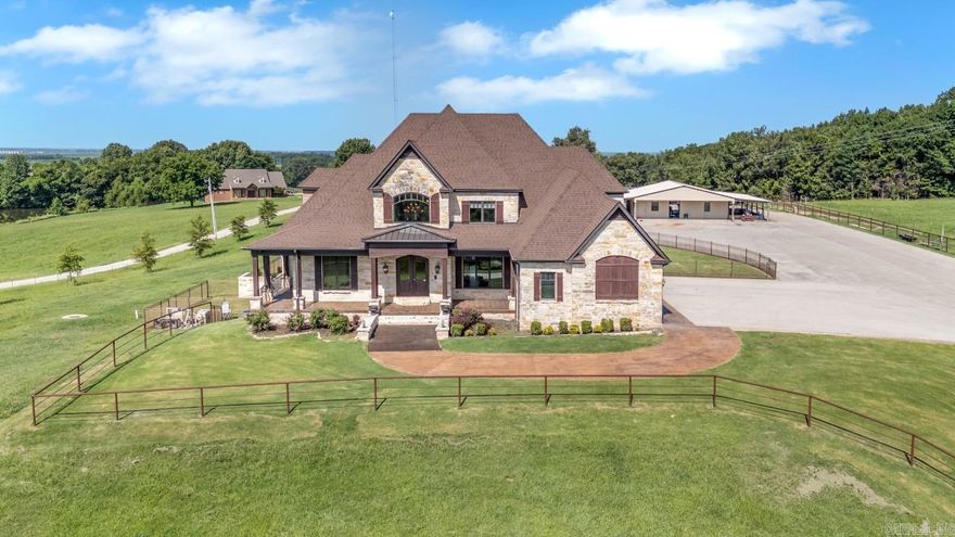 Discover a rare blend of craftsmanship, comfort, and privacy just minutes from Jonesboro. Behind a gated, automated entrance, this 7,350± sq. ft. residence rests on 8.59 acres of manicured pastures, mature trees, and a tranquil stocked pond. Inside are four spacious bedrooms and four and a half baths, highlighted by exquisite cypress woodwork, stone finishes, and expansive windows that invite natural light throughout. The gourmet kitchen impresses with dual islands, stone backsplash, and premium appliances—perfect for entertaining. Enjoy a finished basement, gas and wood-burning fireplaces, smart security with cameras, and seamless access to the saltwater pool and hot tub. The primary suite includes a spa-like bath and private office, while each guest room offers an ensuite. Added peace of mind comes with two safe rooms, a Kohler 60 kW generator, dual 150-gallon water heaters, gas emergency heat, and a new 2025 roof. Outdoors features a mosquito misting system, lighted horse arena, stocked pond, and a barn with guest quarters. Adjoining 53 acres are available for purchase to expand this exceptional Arkansas estate.