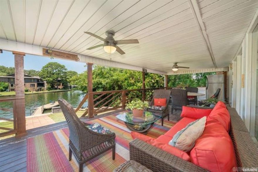 Nestled on the East Shores of a cove just off Lake Hamilton's main channel, this home has tons of interior upgrades mostly done in 2010. Recent new roof, HVAC and HWH. There's a hot tub on the covered lakeside deck of the home. Boat mooring is available on the long pier or swim deck. This could be a wonderful family lake get away or continue on as a successful STR. Plenty of options with this property. The location is very convenient by car or boat and the lot is almost flat. Home is being sold fully furnished and no city STR permit is required as the property is in the county. The yard's sprinkler system has a new lake waterpump