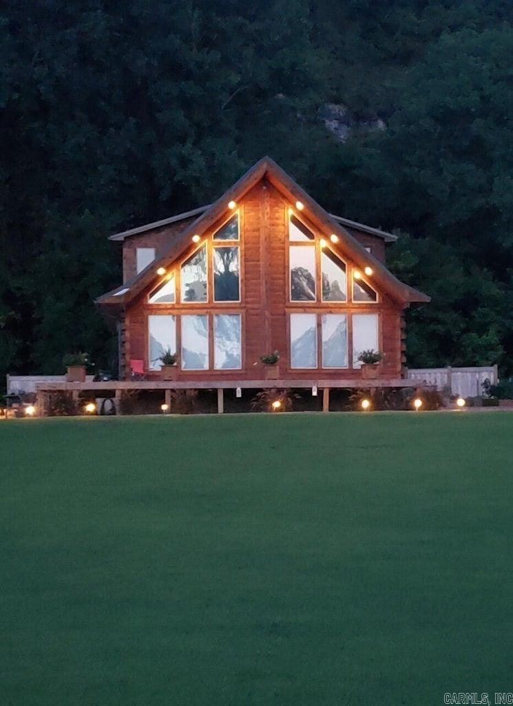 Welcome to Bear Paw Cabin-Western Cedar Log home on the White River! If your Dream Home is a Rustic-Style Log Home in a peaceful River community, look no further! Enjoy the Beauty of the Ozarks along the White River w/gorgeous sunrises & stunning views to enjoy your morning coffee or favorite evening beverage on your brand new deck just watching the River carry your worries away. Plant your fav veggies & flowers in the new raised garden beds & landscaping. New in 2023: stove, micro, disposal, kitchen sink, front & side decks, board-on-board privacy fence. New RGB LED lighting and many new updates & fixtures too numerous to mention. (Owner states property is currently NOT REQUIRED to carry Flood Insurance as it is on back row from the river. )