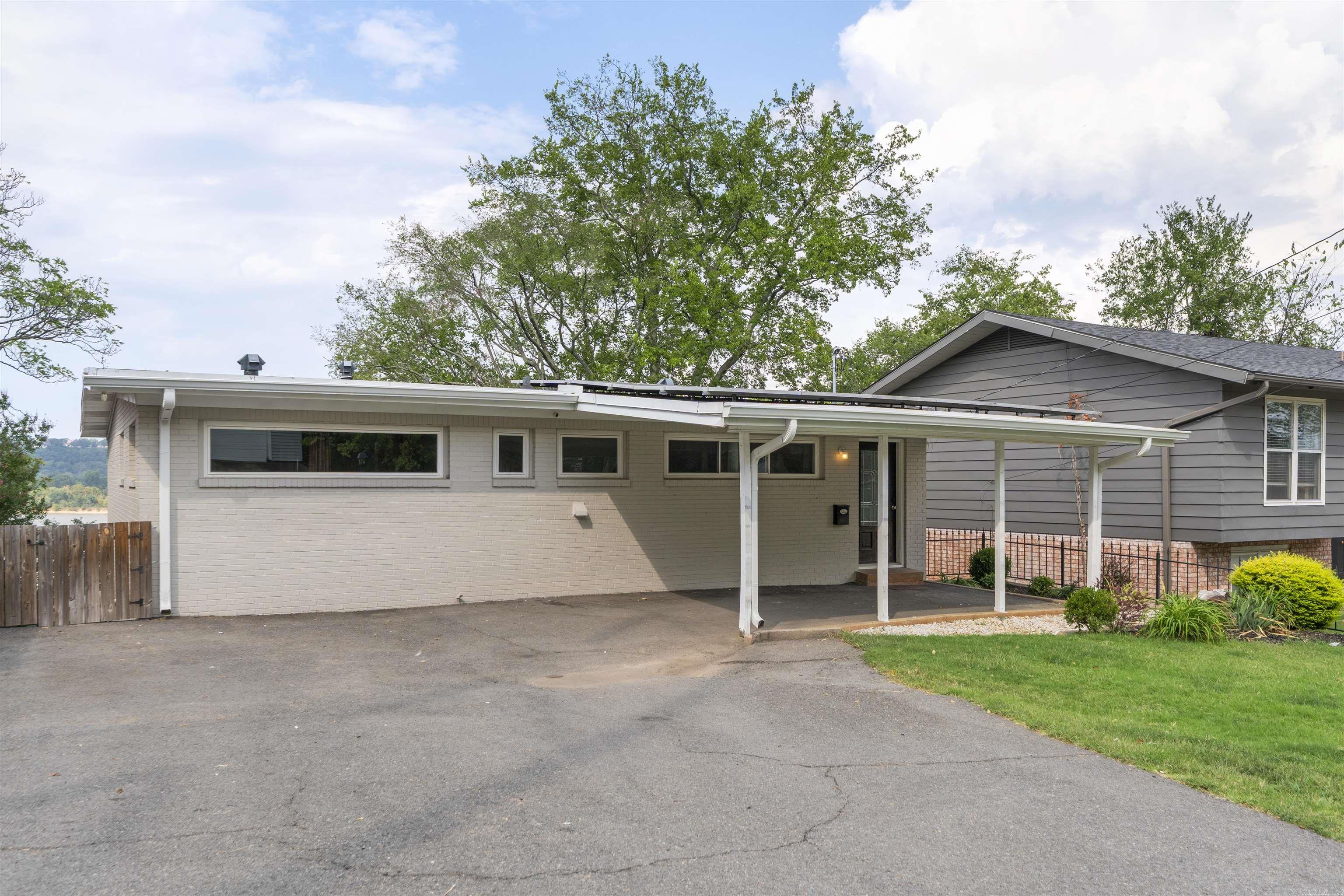If you’re looking for a timeless home that has been updated to modern standards and has an amazing view then look no further than 2012 Riverview Dr. The beautiful original hardwoods flow seamlessly through the oversized bedrooms and into the open and inviting living room that boasts a panoramic view of the Arkansas River! The kitchen has been updated to allow even the most particular chef to enjoy their experience and is open to the living room which creates a great space for entertaining. The lower level has just been updated with tile floors and features another large space that can be used as a game room or second living area. Allow this house to become your home and enjoy everything that Little Rock has to offer! The solar panels keep the electric bills to a minimum and are paid off so there is no solar lien attached to this house.