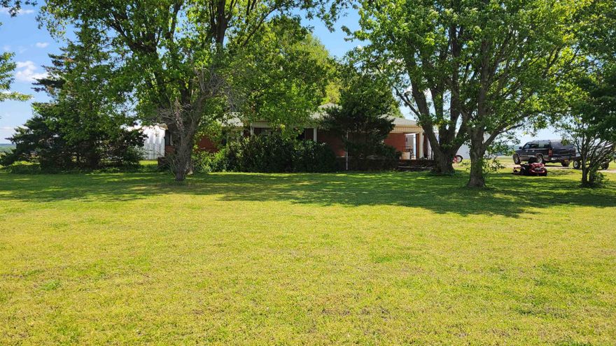 Charming brick home with solid bones situated on 1.06 acres of level, open land offering endless possibilities. This well-built property features a cozy wood-burning fireplace in the large living room. The outdoor space is perfect for gardening, recreation, or future improvements, and gives the peaceful feel of country living. With a strong structure and timeless brick exterior, this home is ready for your personal touch to make it truly your own.