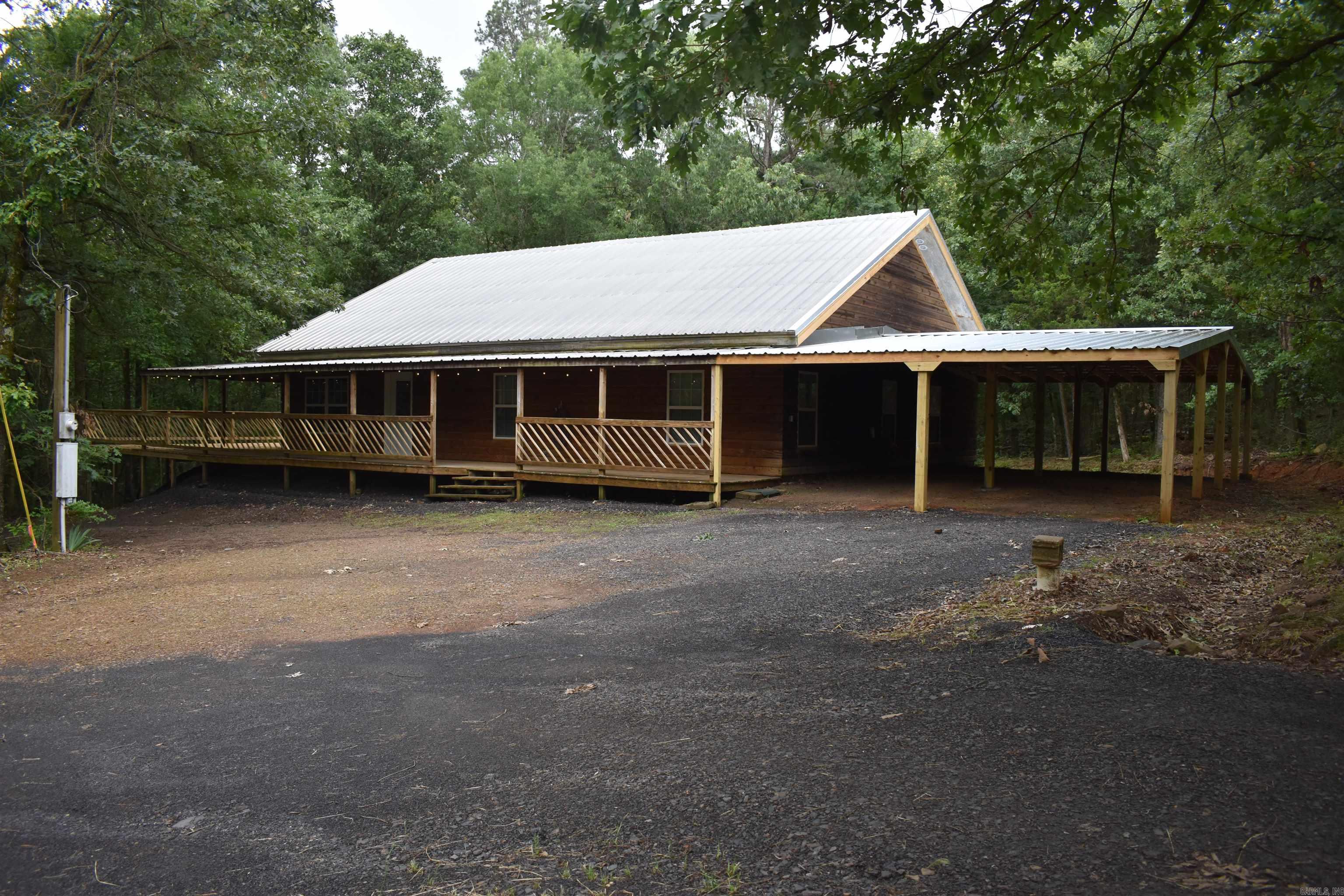 Located just outside of Belleville, this log siding home has been meticulously maintained and is ready for its new owner! The 2448 square foot home is tucked onto 9 quiet acres of mature timber, providing privacy and seclusion that is unmatched on acreage of this size. An attached carport, porch, and deck all add to the amenities that this home has to offer. Just across the yard, the red iron shop provides ample storage and workspace for all things needed for rural living. • 2448 +/- Square foot log siding home • 3 bed 2 bath with loft • Attached Carport • Over 1300 square feet of deck and covered porch • 40x40 red iron shop with two 10x40 lean to’s • Shop has concrete floor, insulation, power, and plumbed for bathroom • 200-amp service in shop • Spacious and comfortable home • Open living area with vaulted ceiling • Large laundry room • Wide hallways and door frames • 448 square foot loft overlooking the living room • Large attic storge space • Spacious closets • Secluded yet convenient setting • No neighbors in sight • 9 +/- Acres covered in mature timber • Good Deer Hunting • Minutes from Belleville • Minutes from Spring Lake • Minutes from Ozark National Forest