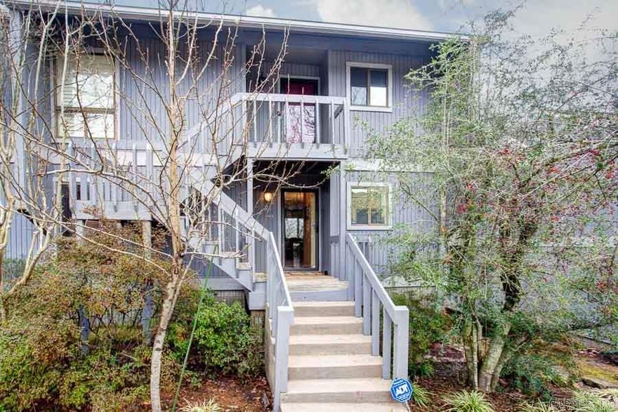 Downstairs unit with treetop views! 2 bedrooms and 2 bathrooms with a large living area with wood-burning fireplace. Master suite with large closets. The enclosed sun porch is the perfect reading nook, space for your pet or storage area. Heat & air new in 2012. Other updates include new kitchen floor, countertop and appliances. Relax and enjoy the peaceful views from your private deck. **Sellers will pay for first year of association dues**