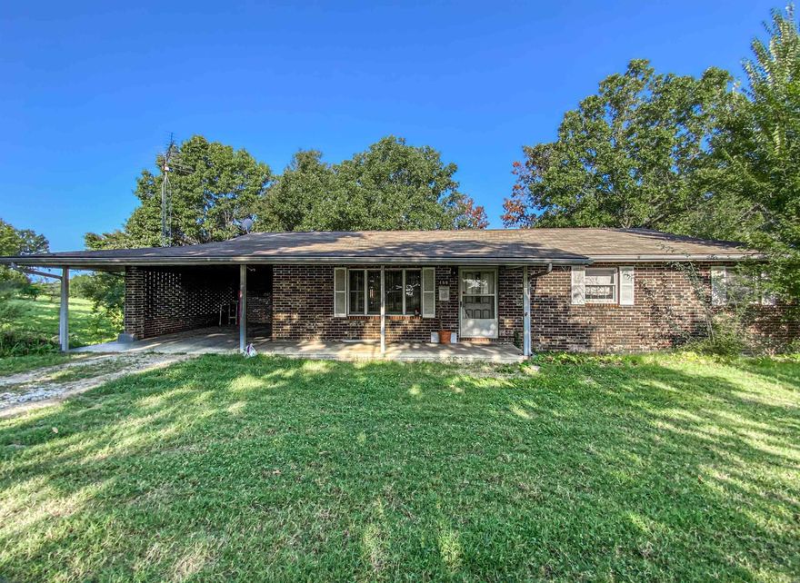 All brick home with large detached shop on 1 acre just off paved county road. The home features 3 bedrooms on main level with one being a master suite with four season room. Basement has additional family room, bedroom with half bath, office, workshop/storage and storm shelter. Roof is 5 years old and HVAC new in July of 2024. Detached shop with auto garage door and home has large deck and carport.
