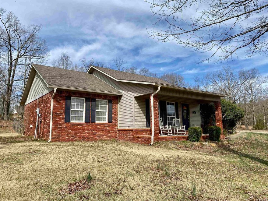 Nestled on a picturesque 2.49-acre corner lot, this charming 3BR, 2BA home offers a perfect blend of privacy and convenience. Surrounded by mature shade trees and established landscaping, the property features a semi-private fenced backyard, a serene fishing pond, and a welcoming front covered porch. Inside, the eat-in kitchen boasts stainless steel appliances, a breakfast bar, and a pantry, while the cozy living area is centered around a fireplace and highlighted by a tray ceiling. The primary suite includes a walk-in closet, double vanities, and a relaxing jetted tub. Step outside to enjoy the peaceful rear patio and park-like backyard. Additional perks include a storage building with electricity and a newer roof (2021). Located just minutes from town, Lake Ludwig, bike trails, and the Ozark National Forest, this home is an outdoor enthusiast’s dream!