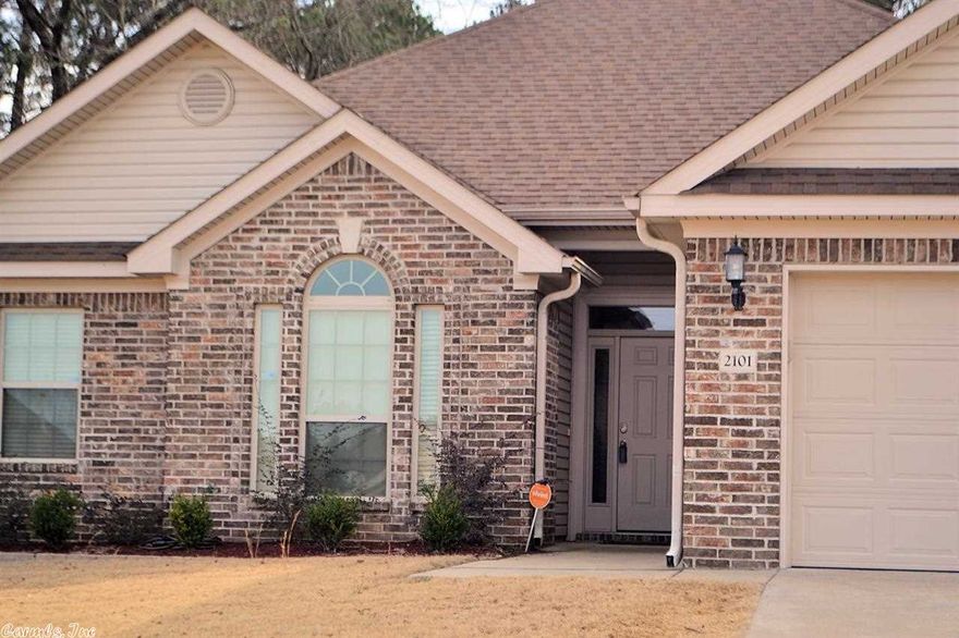 Fabulous 3BDR/2Bath home w/a sun-room (or large office, bonus space), gas log fireplace in living room, kitchen is open to the family room. Granite slab was added to the kitchen. Home has lots of crown molding and walk-in closets in each BR. Master bath has whirlpool tub, separate shower and his/her walk-in closet.  Fenced PRIVATE backyard backs up to private land.  Home is wired for security. Qualifies for 0 down Rural development loan! Bryant schools.  Easy to show!~