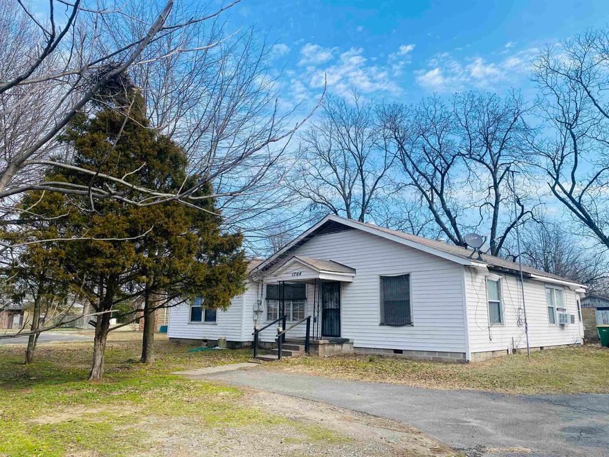 This home sits on ONE ACRE of land and is zoned commercial. Beautiful farmhouse with 3 huge bedrooms, 2 full baths with large kitchen that opens to a sunroom. WELCOME HOME!!!