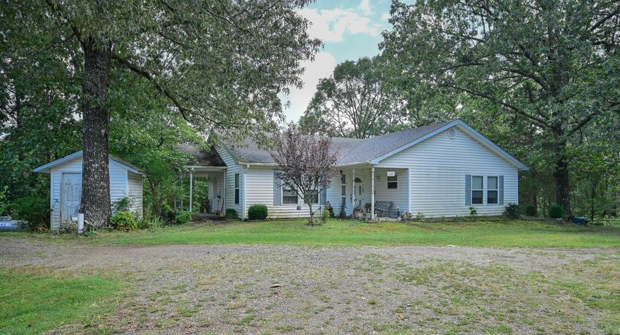 This charming, gated, almost 6-acre farmette features two houses and a mobile home. House 1: 2 bed/2 bath, open concept floorplan with lots of natural light. House 2: 2bed/2 bath, cozy bungalow with wood burning fireplace and sunroom. Dwelling 3: single wide mobile home with screened porch. For the livestock, you will find a barn, stables with eight stalls, a tack house, a chicken coop, and rabbit hutches. The pasture is fully fenced and cross-fenced. Additionally, you'll find a 24x60 workshop and a 16x36 workshop. A spring-fed creek feeds the one-acre stocked pond. Luscious landscaping boasts fruit trees that include apple, pear, and fig, along with mature trees and several ornamental plants that attract the local deer. One side of the property borders Polk Rd 92.