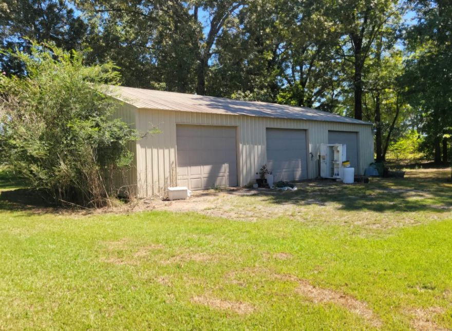 Dream Shop with Country Home Bonus  If you’ve been searching for the ultimate shop space with living quarters included, this property is for you. Located on Highway 425 and sitting on approximately 3 acres, the highlight here is the massive workshop—perfect for hobbyists, craftsmen, or anyone who needs plenty of room for projects, vehicles, or toys.  *The Shop is a 40' x 50' Metal Building on a solid concrete slab *3 large bay doors plus a walk-through door for easy access *Wide-open space perfect for housing vehicles, boats, ATVs/UTVs, or setting up a full hobbyist’s dream shop  *The Home is 2 Bedrooms, 1 Bath | 1,303 sqft  *Bright, spacious living area with laminate flooring *Retro-style kitchen full of charm *Large utility room for convenience *One bedroom currently set up as a craft/storage room *Fenced backyard with a patio for relaxing after a day in the shop *Detached two-car metal carport *Approx. 3 acres with highway frontage *Back pasture area, previously used for horses  This property is ideal for the buyer who values workspace first but wants the comfort of a home attached. This shop is ready to go—and the cozy home is just the bonus. Call to schedule a showing!
