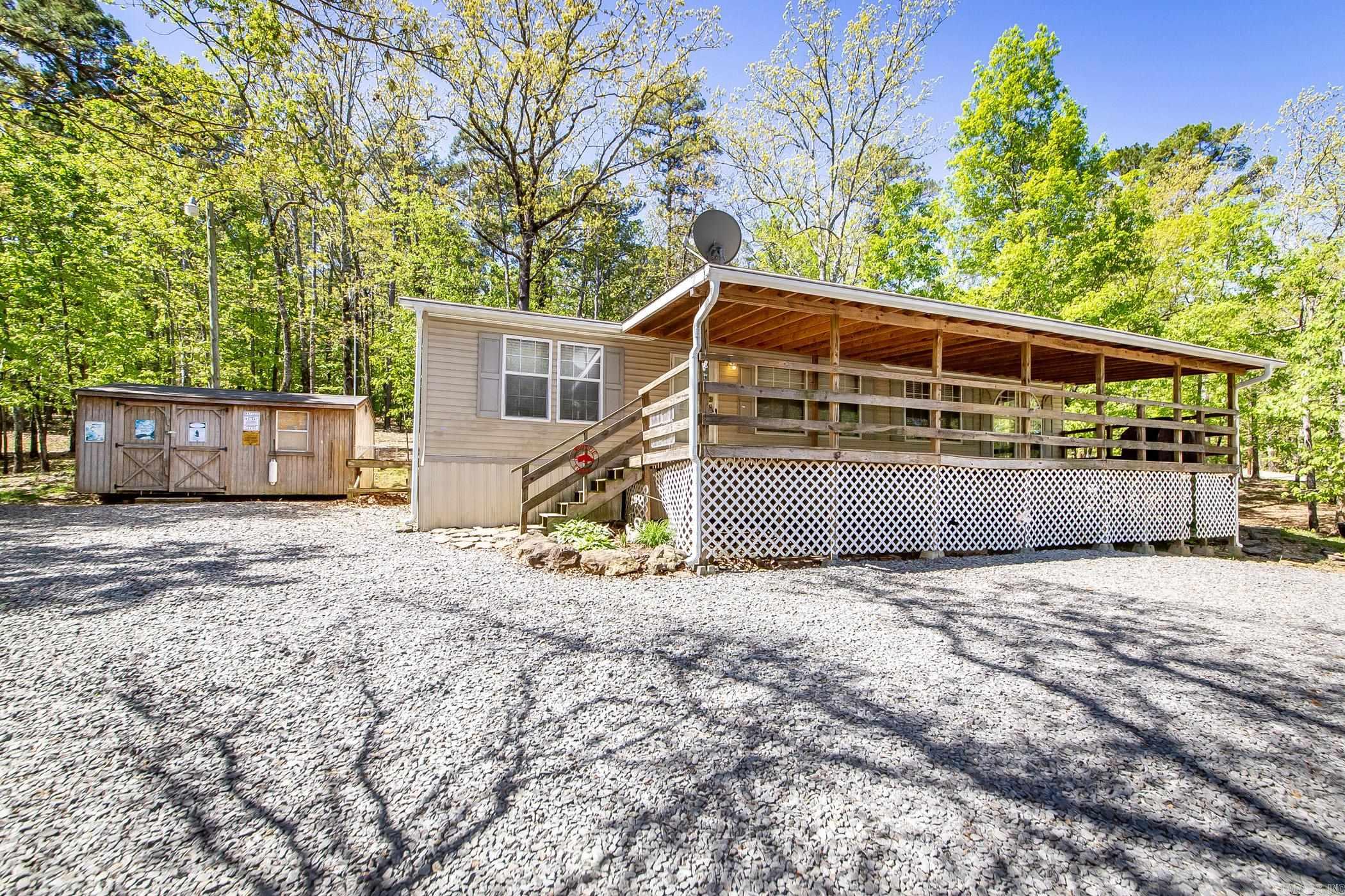 This charming and well maintained home sits on a spacious corner lot that spans three lots total—1.3 acres—offering plenty of room to enjoy the outdoors. Located just a short distance from Mill Creek Boat Launch & Sugarloaf Marina, it’s perfect for lake lovers and weekend getaways. Recent updates include: Water heater replaced in 2019 Roof replaced and covered front porch expanded approximately 6–7 years ago Refrigerator replaced 4–5 years ago New HVAC systems installed in 2017 Brand new dryer in 2024 All appliances and furniture are included, making this a move-in ready opportunity. The sellers used the property for many years as their lakehouse before transitioning to full-time living here for the past six years. Also included is a 10x16 storage building, perfect for storing outdoor gear or tools. The mobile home title has already been cancelled. Additional documents available online under the “Docs” section.