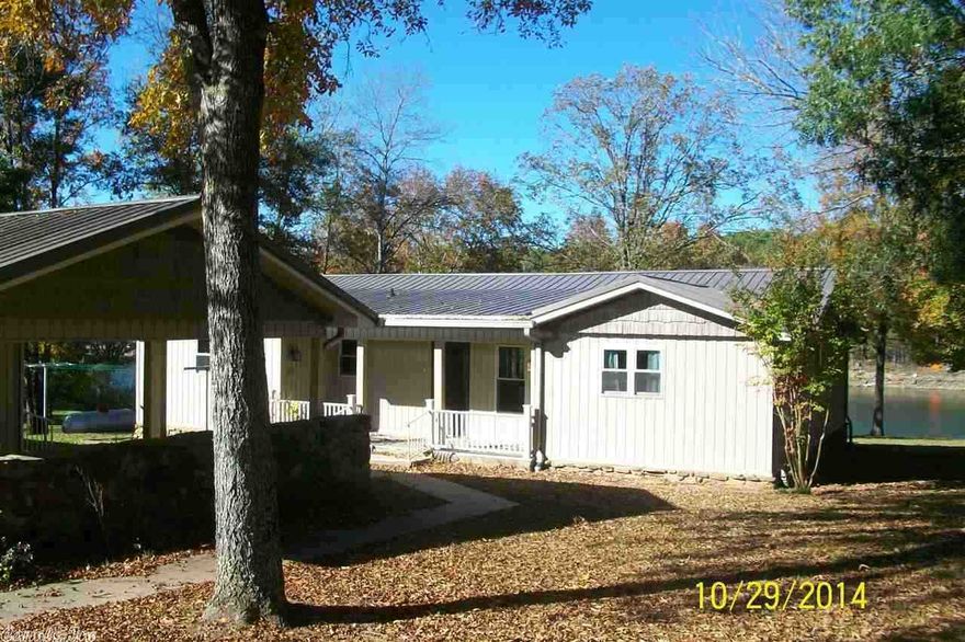 Excellent LAKE FRONT Home with the White Line in the Water "RARE"! Open Kitchen/dinning/living area with vaulted ceilings. Large breakfast bar, 4 bedrooms, 2 baths.  20 X 20 Guest Suite with the 3rd bath.  28 X 36 detached garage plenty of room for all your Lake Toys!!!! Two 20 X 20 covered carports.  The lake frontage has a gentle slope to the water.  Metal roof with vinyl siding. Don't forget the great screened-in back porch for watching the boaters dodge one another (have your camera ready to record)