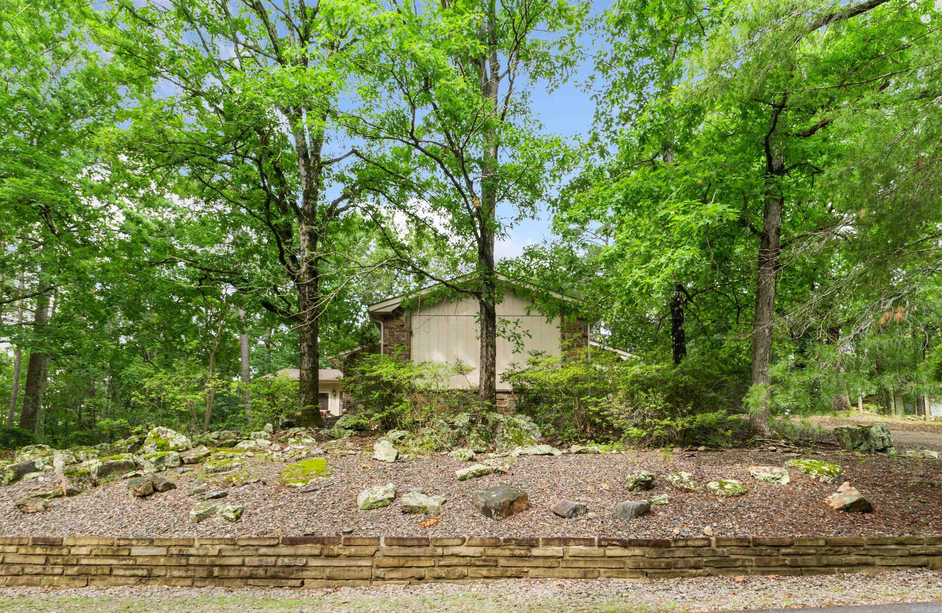 Conveniently located just north of Desoto Blvd. You are welcomed to this well maintained and wooded lot cul-de-sac home via a circular driveway with plenty of parking. This three/four bedroom, 2 bath home has a large flex-room with its own entrance that will serve as the fourth bedroom, an entertainment room or a mother-in-law room. A stone wood burning fireplace awaits you in the great room. Spend time relaxing or entertaining in the large sunroom that overlooks the wooded property through expansive windows. With a built-in Jen-Air Grill why go outside to grill your steaks and burgers. There is a lighted 5x20 storage/work shop. Recent updates include: 2 complete HVAC units, a new roof and skylights in 2024. Vinyl flooring, paint and gutters in 2023. Seller is providing $5000 credit at closing. Hot Springs Village Property Owner Association has a new member buy-in fee of $2,000.00 due and collected at closing