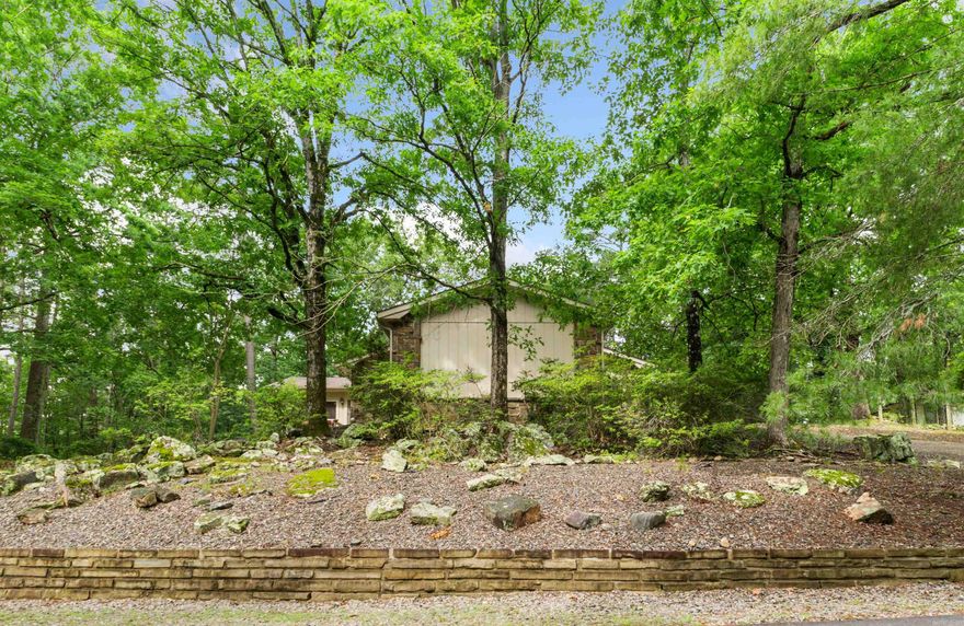 Conveniently located just north of Desoto Blvd.  You are welcomed to this well maintained and wooded lot cul-de-sac home via a circular driveway with plenty of parking. This three/four bedroom, 2 bath home has a large flex-room with its own entrance that will serve as the fourth bedroom, an entertainment room or a mother-in-law room.  A stone wood burning fireplace awaits you in the great room.  Spend time relaxing or entertaining in the large sunroom that overlooks the wooded property through expansive windows.  With a built-in Jen-Air Grill why go outside to grill your steaks and burgers.  There is a lighted 5x20 storage/work shop. Recent updates include:  2 complete HVAC units, a new roof and skylights in 2024.  Vinyl flooring, paint and gutters in 2023.  Seller is providing $5000 credit at closing.  Hot Springs Village Property Owner Association has a new member buy-in fee of $2,000.00 due and collected at closing