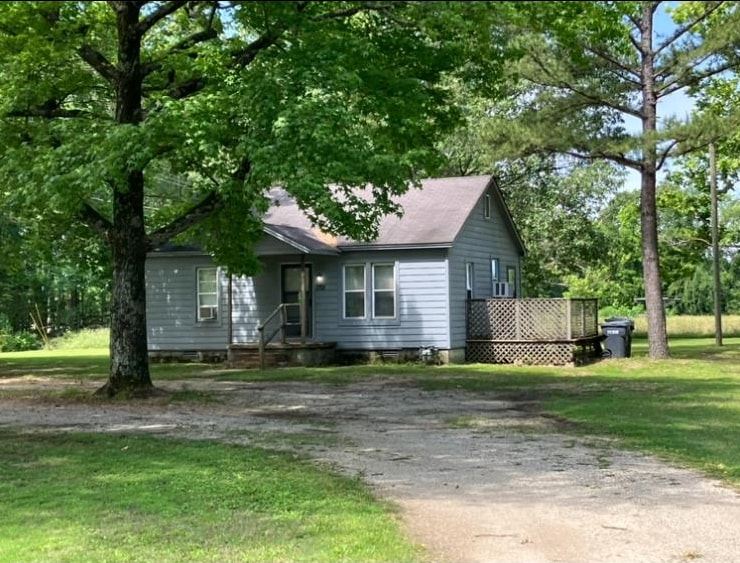 Two bedroom, 1 bath home with a shop building detached (former beauty shop) on a platted .80 acre lot along with additional platted four lots not developed. Property has CWL water, electric, sewer and natural gas.