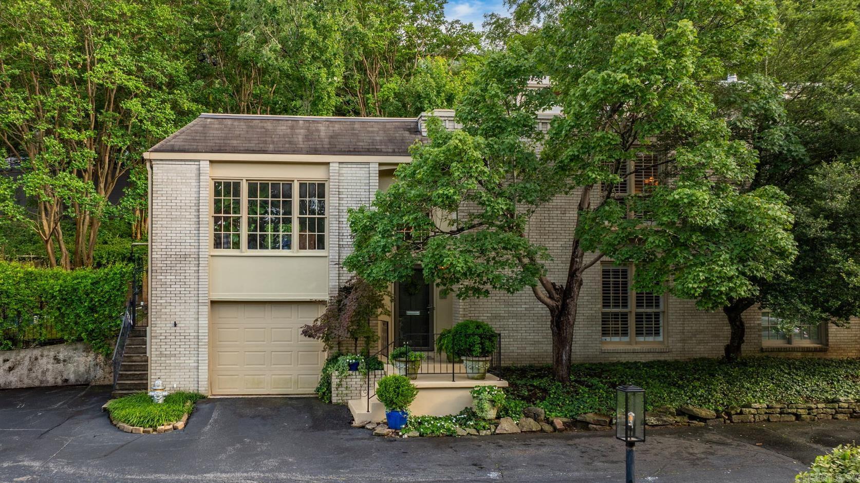 Nestled in the charming neighborhood of Hillcrest, this beautiful townhome feels like a luxurious treehouse retreat. Elegantly appointed and move-in ready. With two bedrooms and two baths, itās been thoughtfully updated to include hardwood floors throughout with carpet in the bedrooms, plantation shutters, crown molding & gas fireplace. The outside back sitting area offers a private retreat. The kitchen features stainless appliances, granite countertops, glass tile backsplash & gas oven. The large windows in the living area look out onto the trees in Allsopp Park. A second living area could be used as an office or TV room. The primary bedroom includes a walk-in closet and en-suite bath. Recent updates include tankless water heater, new dishwasher, custom-built mantel, fixtures, lighting, ceiling fans, fresh paint throughout. Garage with extra storage space. POA fees cover gas, water, sewer, trash, recycling, exterior maintenance & insurance, termite contract, quarterly pest service, landscaping, access to the pool, clubhouse & exercise room.