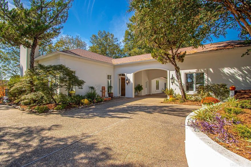 This stunning one-level Mediterranean home offers the perfect blend of luxury, comfort, and functionality — ideal for both everyday living and entertaining! Custom-built with exceptional attention to detail, this home features 12-ft and 10-ft ceilings throughout, custom cabinetry, and marble flooring in the baths.  The chef’s kitchen is designed for both beauty and performance, complemented by a tankless hot water heater, whole-house natural gas generator, and new wood flooring (2024) through the den, entry, kitchen, hallway, and two bedrooms.  Enjoy year-round relaxation in the heated and cooled sunroom, accessible from five entrances and spanning the entire back of the home — seamlessly blending indoor and outdoor living.  The primary suite offers his-and-hers design for ultimate privacy and convenience. The home’s drive-through front entrance, detached 2-car auto garage, and beautifully landscaped grounds with two fountains add curb appeal and sophistication.  Don’t miss this rare opportunity in sought-after Lakewood!