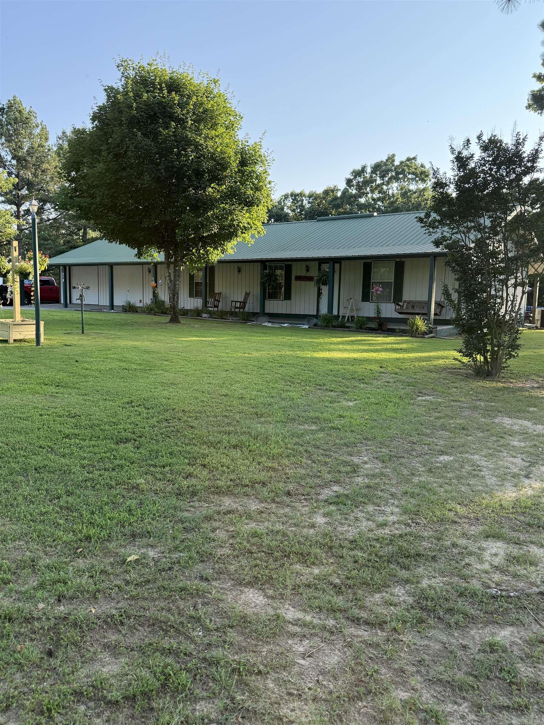 This 3 bedroom 2 bath with 2 car garage home sits on the most immaculate 40 acres you can find. Covered porches front and back 2 ponds, 24 by 24 pole barn type equipment shed, 12 by 12 storage building along with a large storm shelter.