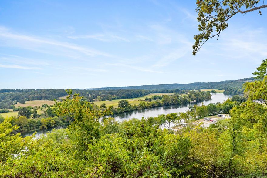 Nestled on a sweeping 6.81-acre parcel overlooking the pristine waters of the White River, this unique real estate opportunity in Cotter, Arkansas, embodies the spirit of tranquility, adventure, and possibility. Whether you dream of building a luxurious family retreat, an angler's paradise, or a peaceful riverside escape, this remarkable property offers the perfect canvas for your aspirations. Features: Existing KDAT treated foundation, 10x10 true CCA materials, ¾” salt water treated decking, underground electric with 200 amp service, city sewer with lift station, RV pad w/hookups, ready for propane tank. Utilities in place, just add your vision to this exceptional property! This property boasts an extraordinary vantage point above the White River, renowned for its crystal-clear flow and world-class trout fishing. The rolling landscape provides not only privacy but also a commanding view that stretches for miles, capturing the essence of the Ozarks in all their unspoiled glory.