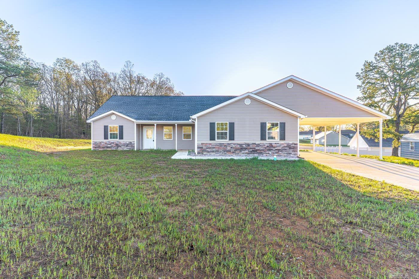 Welcome to Market 2516 Rebecca Dr. of the Cozy Country Estates Sub. in Pocahontas, AR within the Pocahontas School District. Situated on a .32 +/- acre level lot is a 2024 Newly Constructed and Move-In-Ready Cozy Country property. The exterior is wrapped in stone & vinyl and accented by shutters, gutters, a 2 car attached carport, and patio out back. The interior features 1,935 sf of well laid out living space that includes an open concept living/kitchen/dining area that holds a soaring ceiling, eat-in kitchen with quartz topped island, stainless steel appliances, ample cabinet & countertop space, and access to the patio. Unique in it's design, the living quarters hold a primary bedroom with tray ceiling and an en-suite with dual vanity and shower tub combo, a deluxe guest suite featuring a living area, bedroom, kitchenette, and en-suite with walk-in shower, 2 spare bedrooms and spare bathroom with shower tub combo. You'll love the vaulted ceiling, luxury vinyl flooring, and contemporary color palette. Conveniently located near favorite local amenities and just 45 minutes to Jonesboro and Paragould. Call today to schedule a tour and make this new construction house your home.