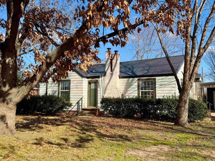 Completely remodeled bungalow that beautifully retains its original charm and character. Updates include new flooring, fresh paint, fixtures, and a new HVAC system. Tawny Oak LVT flooring complements the stainless steel appliances, including a stainless kitchen sink. Features a new 3-ton HVAC package system, extensive plumbing and electrical updates, and a Rheem tankless water heater.  Bright and airy interior with abundant windows, neutral Sherwin-Williams paint, and dark trim and doors that highlight the original woodwork. Formal dining room. The updated kitchen includes granite countertops, new shaker cabinet doors (to be installed), appliances, and under-counter lighting. A gas fireplace adds warmth and character. Updated bathroom and custom lighting throughout.  Outside you’ll find a double metal carport with an attached shop, all situated on a spacious, tree-covered lot.