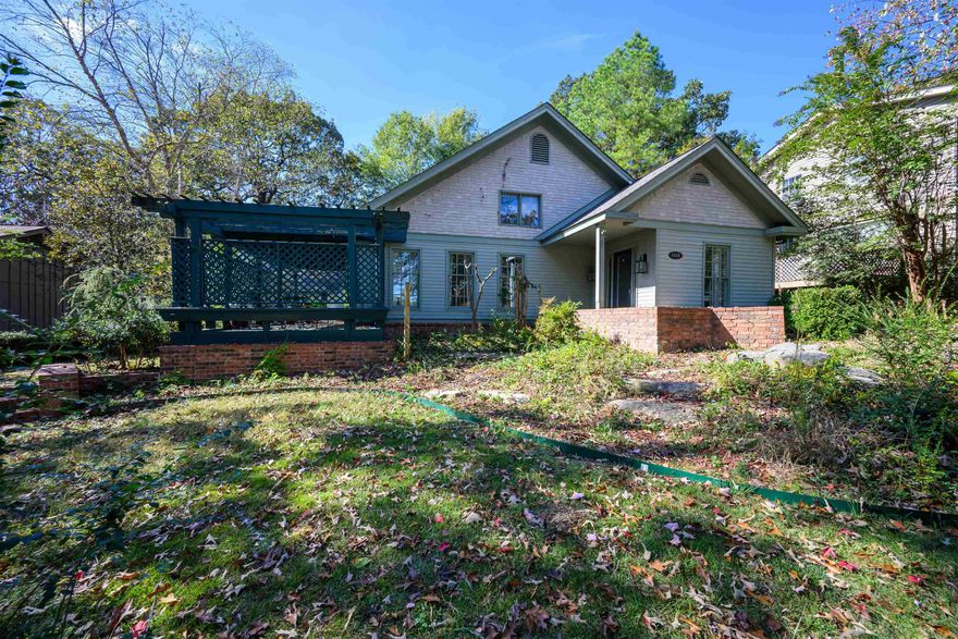 IT IS ALL IN THE DETAILS & you will find LOADS of those in this tidy cottage style home! Step into soaring ceilings, a skylight& walls of windows bringing in natural light! The foyer leads into the SPACIOUS open concept living room, kitchen & dining space! Talk about a chef's kitchen- double oven, gas range, large pantry! Step outside from both the living room & the primary ensuite onto separate pergola covered decks for a country feel while living in town! Let's talk primary ensuite! Custom built ins, vaulted ceilings with skylight & so much SPACE! The attached bathroom is a retreat of its own- large tub, separate shower, double vanities, CUSTOM walk-in closet! NEW ROOF IN 2025 & HVAC replaced within last 2 years! Find parking at both front and back of the home & a storage building!
