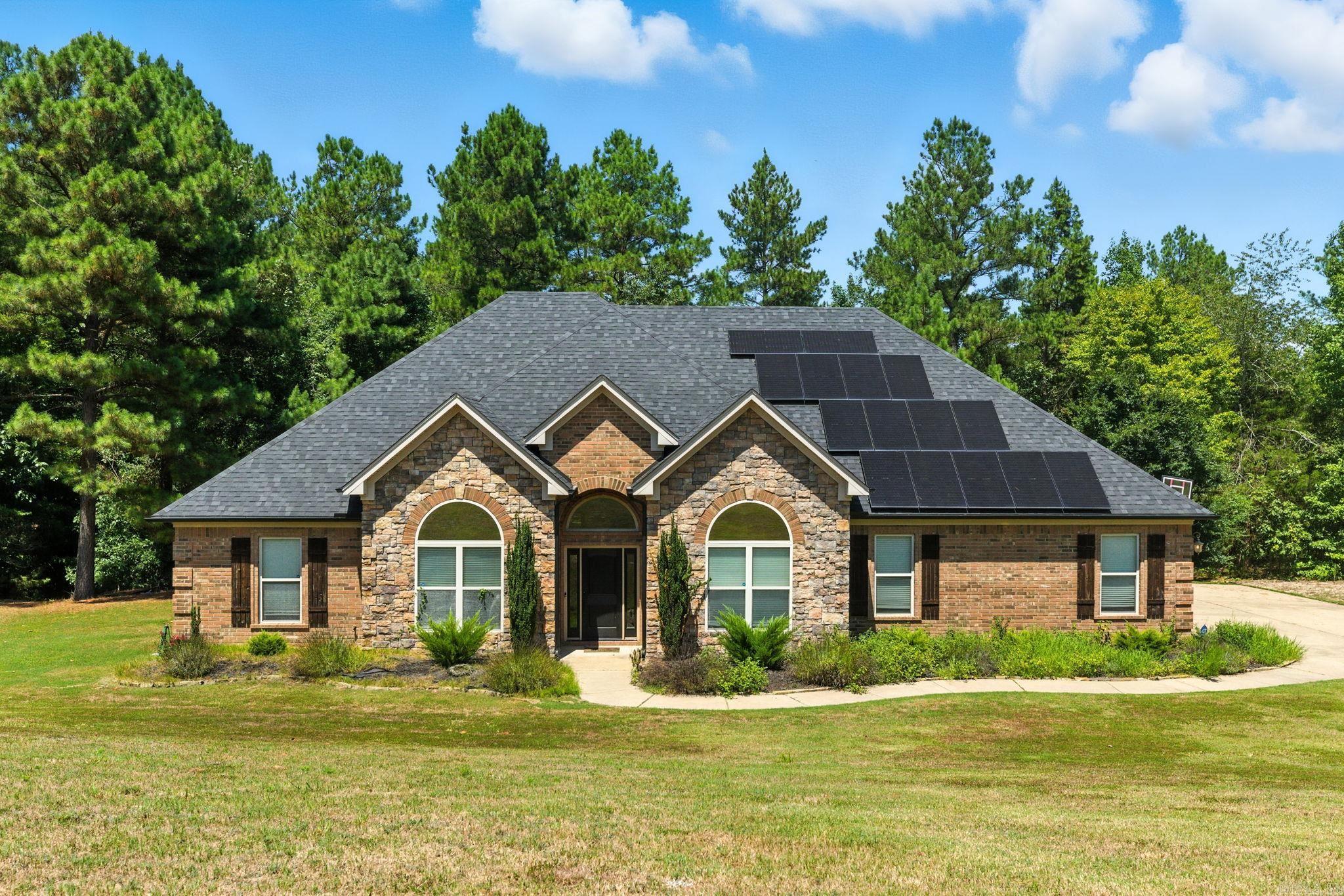 This gorgeous 4 bedroom 3 full bathroom house sits on apprx 1.14 acre in sought after StoneHill off Springhill Rd in Saline County. This home boasts gorgeous wood floors throughout formal dining room and large open living room. Beautiful brick gas start fireplace makes this living room feel just like home. The large open kitchen has fabulous subway tile backsplash, lots of cabinets and the perfect amount of space for entertaining guests or family. Just off the kitchen is a spacious breakfast area that leads to the private backyard with patio and outdoor fireplace. This home lives like a one level with just one bonus room/bedroom upstairs with it's own private full bath. Large master bedroom with woodfloors. Mater bath with double vanities, seperate tile shower and jetted tub. Large walk in closet. 3 car garage with storage. Alarm. New roof 2022. Septic pumped in 2023. Country living convineint to everything.