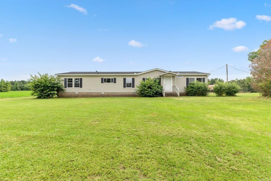 Get ready to live the good life in this stunning mobile home, nestled on 0.86 acres of country bliss! With sheetrock walls, warm wood cabinets, and sleek Whirlpool appliances, cooking and entertaining are a breeze. The spacious bedrooms have walk-in closets for ultimate relaxation. And with new paint and flooring, you'll feel like you're living in a brand new home! The private, fenced-in backyard is perfect for hosting outdoor gatherings or just enjoying the peace and quiet. Plus, a brand new roof installed in 2024 and gutters give you peace of mind. The permanent foundation allows this home to go almost all loan types. Welcome home!