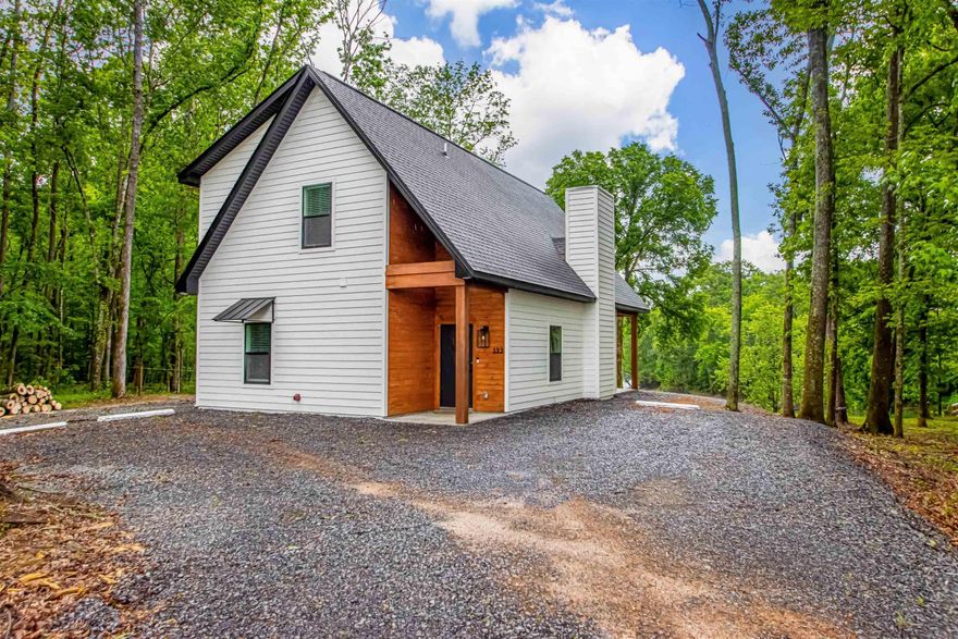 Welcome to “The Ivory,” a stunning new luxury cottage set on over 1.5 acres along the banks of the sought-after Little Red River. Whether you’re dreaming of a private retreat or a high-performing short-term rental, this fully furnished home is ready to impress. Inside, the open floor plan features vaulted ceilings, a cozy stone fireplace, and a chef’s kitchen with quartz countertops, tile backsplash, stainless steel appliances, and a central island perfect for gathering. The main-level primary suite includes a walk-in closet and a custom tile shower. Upstairs offers a spacious guest bedroom, a full bath, and a versatile loft with a closet that can serve as a bunk room, playroom, or additional guest space. Step outside to relax on the oversized vaulted back porch and take in the peaceful river views, or head just a few steps to the brand new shared dock. With all furnishings, decor, and essentials included, The Ivory is turnkey and truly move-in or rental ready. Just minutes from town and just over an hour from Little Rock.