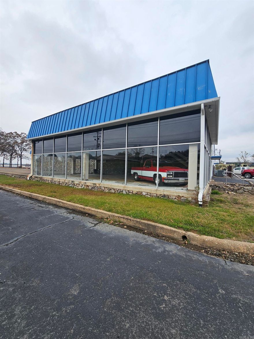 Discover an exceptional commercial opportunity with this spacious former automobile dealership, now primed for a wide range of uses.  Situated on a high-visibility lot, this property offers a flexible layout and solid structural foundation-ready to be transformed to suit your business vision.  Inside, the building has undergone some interior demo.  We estimated the parking spaces.