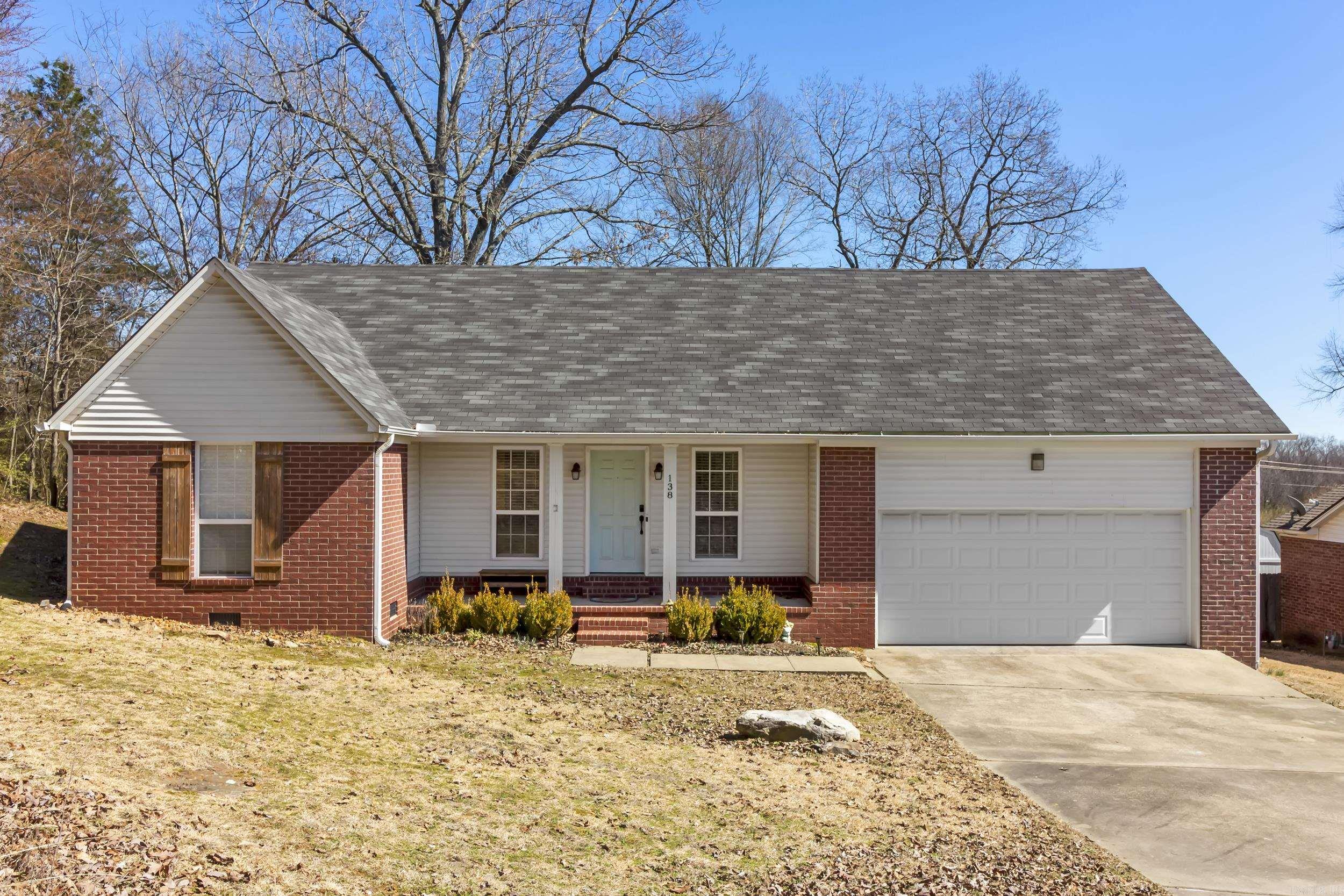 This beautiful home features a desirable split floor plan with three bedrooms and two full baths, perfect for comfortable living. The large, open living room boasts an electric fireplace and flows seamlessly to the kitchen and dining. Here you will find quartz countertops and ample storage. Wood-look laminate flooring runs throughout the home, adding warmth and easy maintenance. A spacious garage provides plenty of parking and storage, while a large deck and cozy firepit offer the perfect spots for outdoor entertaining. Nestled at the end of a quiet street, this home offers peace and privacy while being conveniently located near downtown Searcy. Don't miss out on this move-in ready gem - refrigerator, washer & dryer stay!