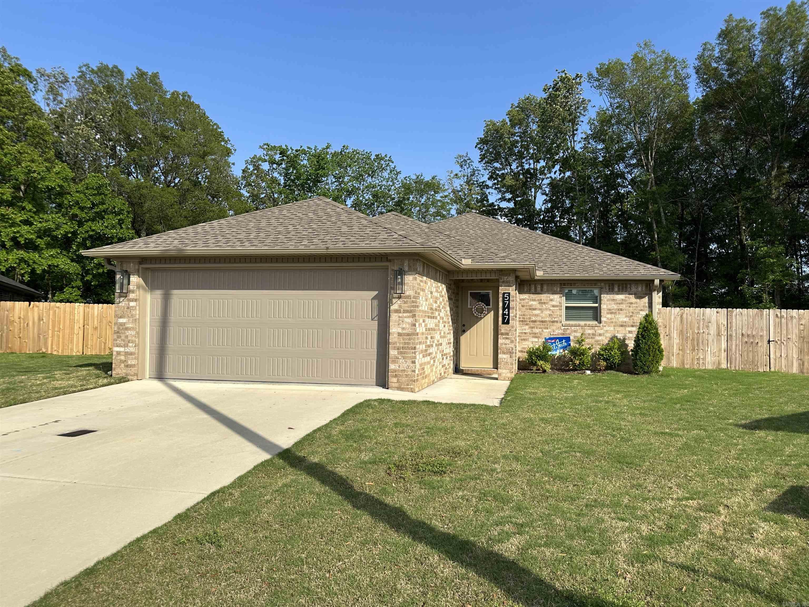 Don't miss this beautiful and spacious 3-bedroom, 2-bathroom brick home with an open floorplan! Only 2 years old, this home offers numerous upgrades, including one of the largest lots in the neighborhood with a wood privacy fence, a screened-in back porch, custom blinds, and more. The refrigerator, washer, and dryer are included, making this move-in ready property even more convenient. Come see all the extras this stunning home has to offer!