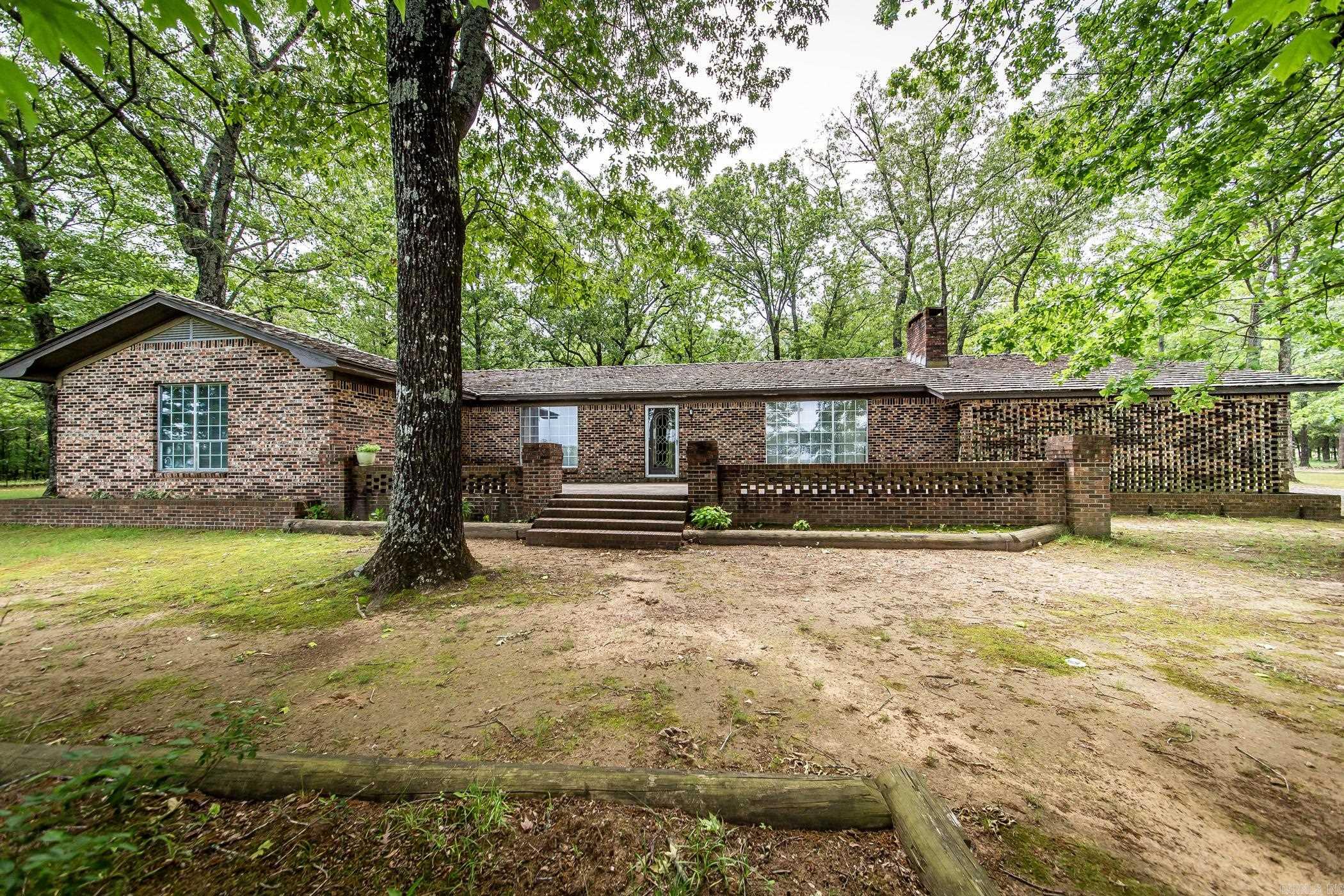 Welcome to a unique opportunity to create your perfect haven. Situated on a picturesque 48 acre expanse located between Heber Springs & Quitman. Just 10 minutes to Greers Ferry Lake, this sprawling ranch offers a blend of comfort, space, & natural beauty. The one-level, all brick home boasts a generous & well thought of layout, featuring 4 spacious bedrooms & 3.5 baths. While the home awaits your personal touch & modern updates, its expansive rooms offer endless possibilities for customization. Some photos has been virtually staged and updated to help you imagine the possibilities. Surrounded by a breathtaking landscape of mature trees, flat land, great for horses & some cattle. A perfect mix of lush pastures & enchanting wooded area, the property sets a serene & picturesque backdrop for both relaxation & outdoor activities. Included on the property are multiple storage buildings complete with a half bath, presenting ideal spaces for workshops, hobby rooms, or for your tractor/mowers & other toys. A large tranquil pond enriches the outdoor space, perfect for fishing or simply enjoying peaceful moments by the water. Mineral rights do not convey. A must see.