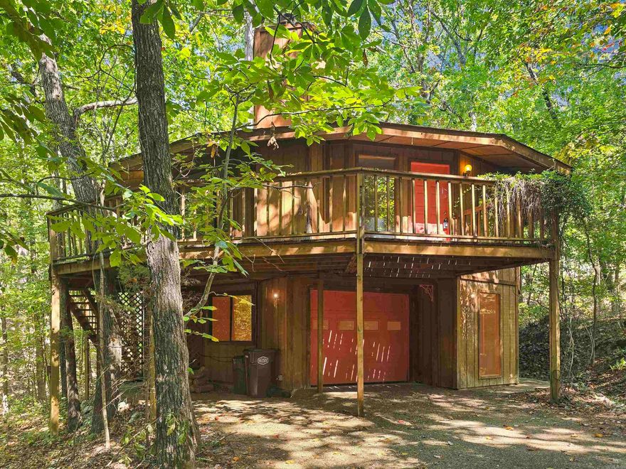 Welcome to the Geo house! This unique 3 bed, 3 bath treehouse is quietly tucked just minutes away from both Lake Cortez and Lake Desoto in the beautiful Hot Springs Village. Totally immersed in nature with no neighbors in sight. You can walk right out the door and onto a private hiking trail! This would make the absolute PERFECT short term rental or an unconventional dream home for nature lovers! Boasting 4 sliding patio doors to bring the outdoors in. 2/3 rooms have walk in closets, 2/3 rooms have a private patio/deck, and there's a bonus room. The geometrical shape adds durability and energy efficiency. Property sold as is and is a blank slate for your vision. AGENTS SEE REMARKS