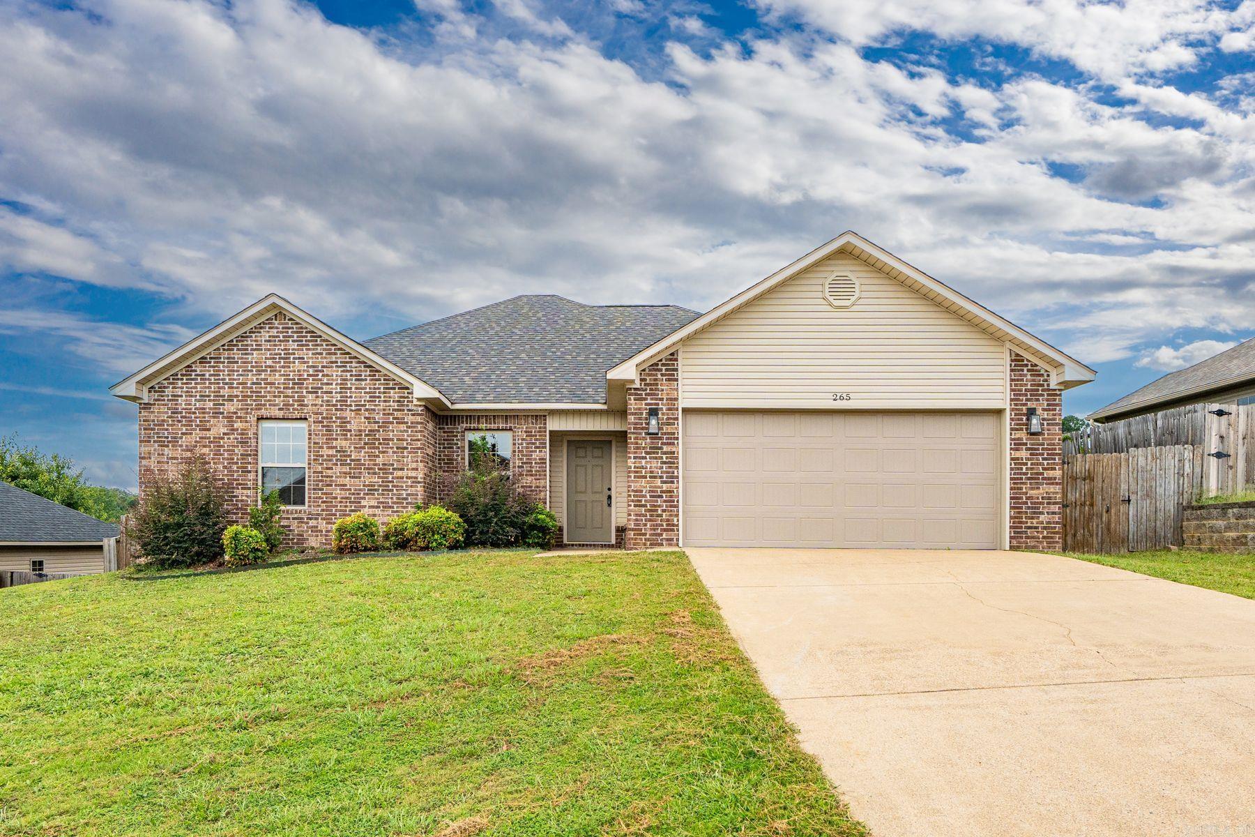 Welcome to this charming home in the Lake Hamilton Park Subdivision, built in 2010 and offering 1,664 square feet of comfortable living space. Designed with a one-level, split floor plan, it features 3 spacious bedrooms and 2 well-appointed bathrooms. The inviting family/living area includes a cozy electric fireplace and a dedicated breakfast nook, perfect for everyday gatherings. The kitchen is equipped with stained cabinetry and modern appliances, including an electric range, oven, microwave, and dishwasher—ideal for both casual meals and entertaining. Outside, enjoy a fenced backyard and a covered patio, providing ample space for relaxation and outdoor activities. Combining the tranquility of suburban living with easy access to city amenities, this home offers the best of both worlds.