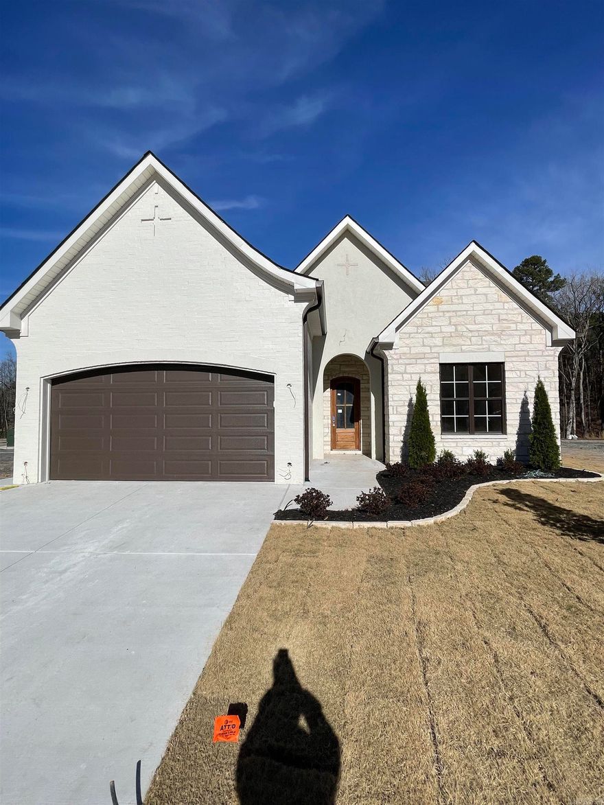 All brick with stone accents, this 4-bedroom, 3 full bath single-story home in West Little Rock blends custom design with everyday comfort. Step inside and feel the openness from 10-foot ceilings and 8-foot solid wood doors that fill the space with light and style. The living and dining area takes center stage with a soaring 16-foot vaulted ceiling and a kitchen equipped with top-tier appliances, ideal for gathering, cooking, and entertaining. Each bedroom is crafted for comfort, and the single-level layout makes daily living simple and functional. Outside, a large pie-shaped lot offers extra space and privacy, backing up to green space and a quiet spring. Just a short walk from the brand-new pool and park now under construction, this home puts resort-style living right in your neighborhood. A true mix of craftsmanship and convenience. Ideal for families, entertainers, or anyone ready for an easy, elevated lifestyle. Estimated completion: February 2026.