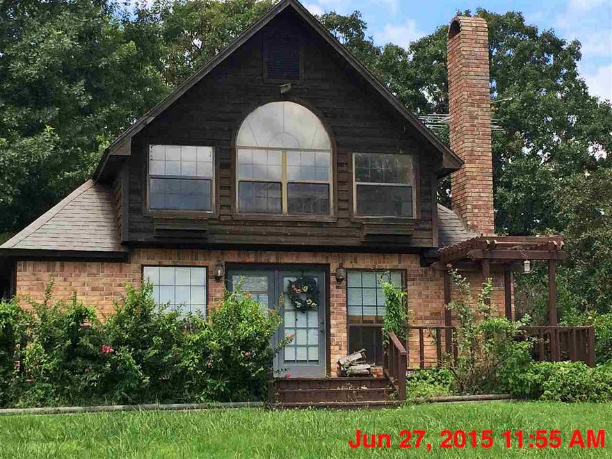Beautiful Two Story 3 bedroom 2 full bath Country Home: Sits on hilltop: Exterior is of Brick and Wood: Lots of Beautiful Windows Across the Entire Front: Front and Back Decks with railing. The walls inside are covered in Pine Wood and Sheet Rock, The custom cabinets, built in's, vanities and interior doors are all of Solid Pine Wood: Spacious Kitchen with 2 Seat Island that includes a extra sink. All Kitchen appliances stay with the home. Upper level includes, Master BRM/BTH with Jacuzzi.