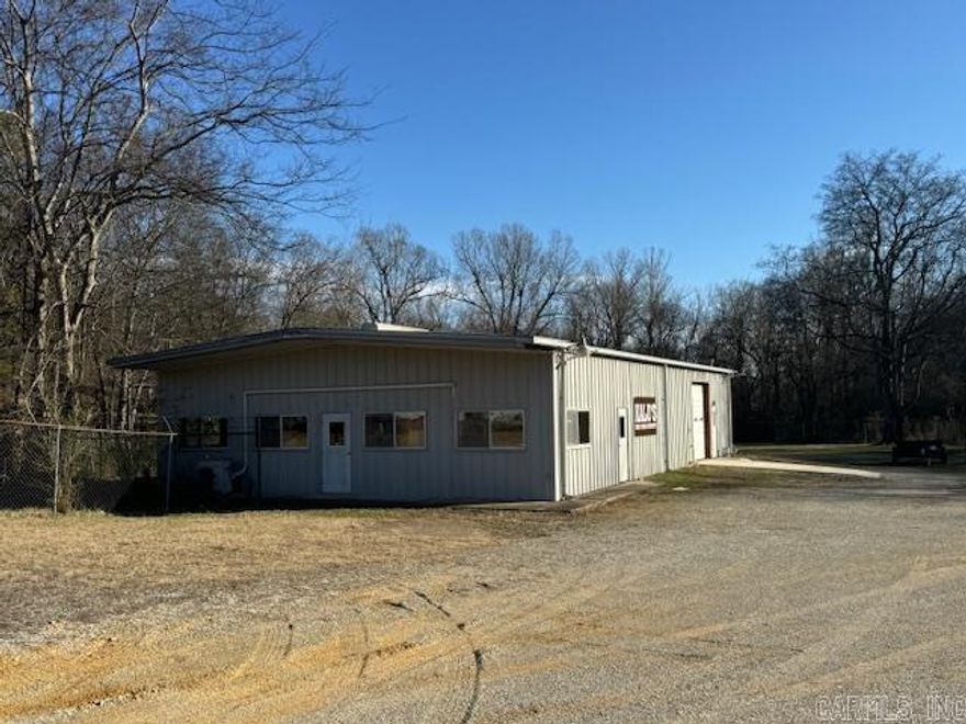 NEW PRICE!! High visibility with tons of flexibility!  2800sqft red iron commercial building sitting on fully fenced 1.16-acre lot. If you're looking for a commercial setup that's ready to go on day 1, this is your chance. The building is fully insulated and features a 2 head mini split, 3 walk through doors, 2 overhead doors, office spaces, and 1 bathroom. This property has high traffic counts and is a great location for a mechanic shop, car lot, retail, or office space.