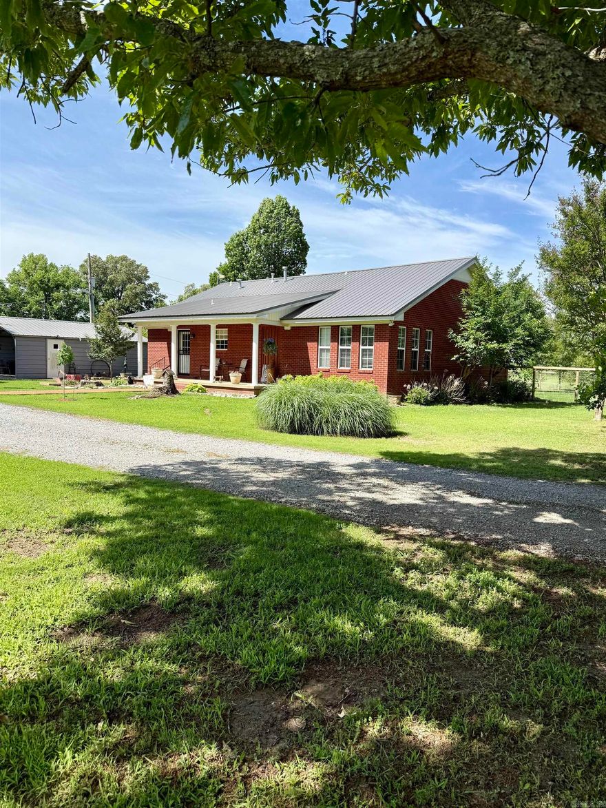 Welcome to your own slice of the Arkansas Delta!   Nestled on 11.3 acres just south of Marvell, AR in a small community called Trenton, this beautifully maintained 2 bedroom, 2.5 bathroom home offers the perfect blend if comfort, functionality, and country living.   Step inside to an inviting open- concept layout featuring vaulted ceilings with exposed wood beams, warm wood accents, and abundant natural light. The spacious kitchen is the heart of the home, complete with a large island, ample cabinetry, and modern appliances- ideal for entertaining or everyday living. The adjoining living room area provides a cozy yet open space to relax, highlighted by large windows overlooking the property.   Enjoy peaceful mornings and evening on the covered porch, taking in scenic views and quiet surroundings. Outdoors the property truly shines with a stocked pond, open acreage, and plenty of room for livestock, recreation, or simply enjoying the outdoors.   A large metal shop offers excellent storage for equipment vehicles or hobbies, making this property as practical as it is charming.