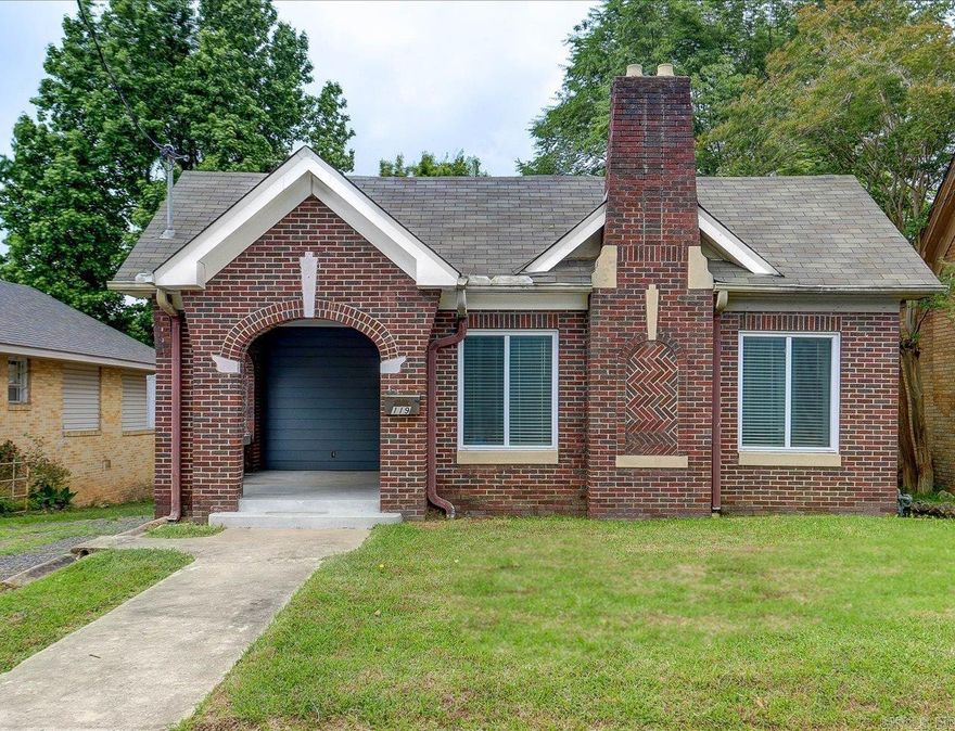 HISTORIC BUNALOW WITH BEAUTIFUL MODERN INTERIOR IN A CENTRAL LOCATION!   This beautifully updated 2 bed, 2 bath, all-brick home is just a few minutes from Downtown Hot Springs, Bathhouse Row, shopping, dining, the National Forest, hiking and biking trails, and Oaklawn.  The open-concept living, dining, and kitchen areas offer a seamless flow—perfect for everyday living and entertaining. The kitchen features concrete countertops, upgraded appliances, a ceiling-height backsplash, and a built-in water filtration system.  Both bathrooms have been fully renovated in recent years—one features a walk-in shower, the other a soaking tub with a rain shower combo.  Additional highlights include a full-size laundry closet, floored attic space for storage, and a walk out basement area that can serve as a storm shelter or be finished to suit your needs.  Enjoy the covered front porch, plus the peace of mind that comes with a newer roof, windows, water heater, updated plumbing, and modernized electrical systems.  With a clean, modern interior, new roof in 2022, and a low-maintenance yard, this centrally located gem is move-in ready!  Agents - please schedule all showings with Showing service.