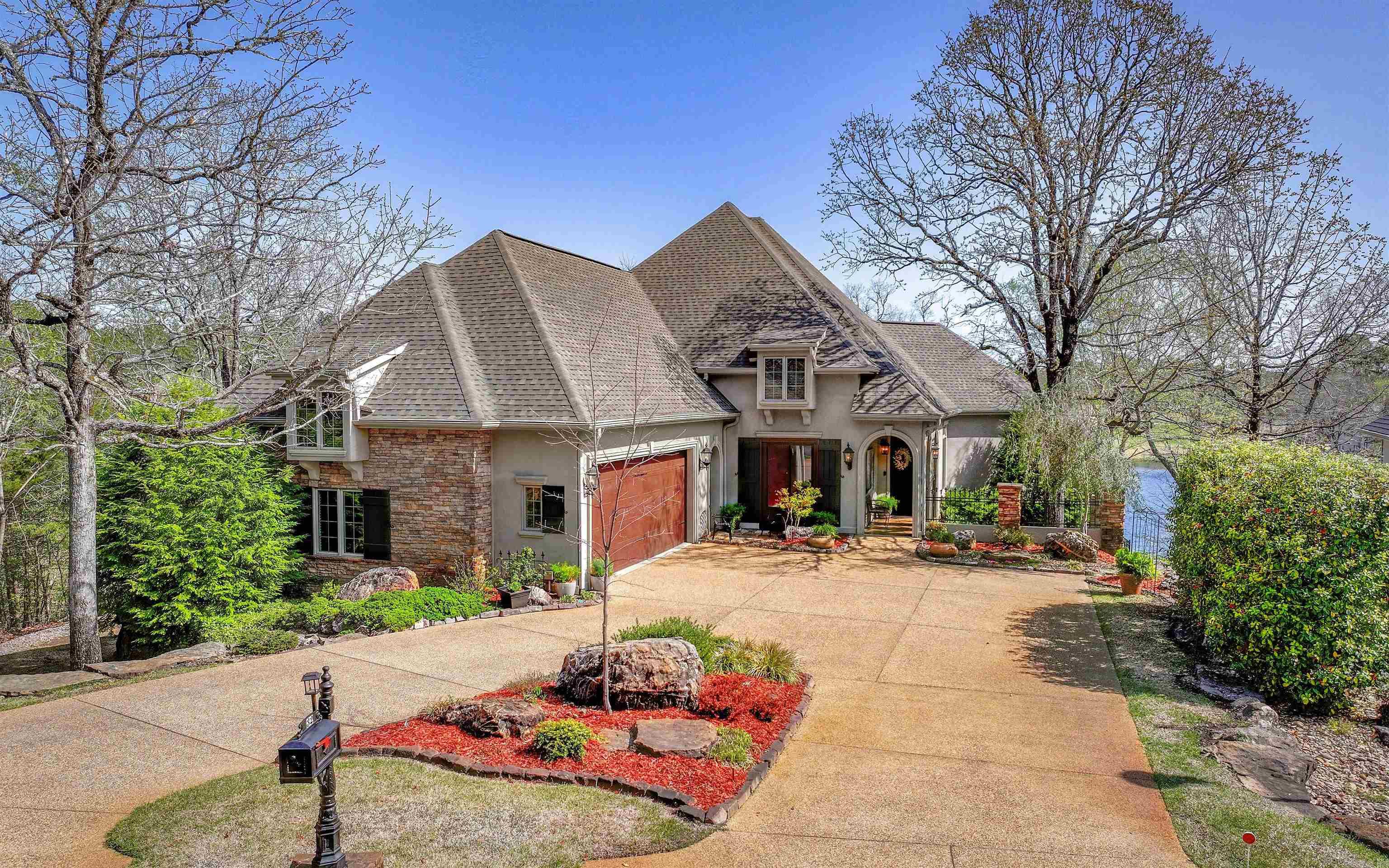 GORGEOUS Custom Home on Lake Isabella with Panoramic Views over the lake and Isabella Golf Course! French-style exterior with stunning curb appeal and professionally designed landscaping. 130' seawall on the lake with a view of the par 3 Nina fairway! Open floor plan accentuated with volume ceilings, walls of windows, gleaming hardwoods, stacked stone fireplace, and well appointed kitchen with large center island & walk in pantry. Gorgeous furniture-quality cabinetry and crown moulding throughout! In addition to the oversized garage, there is a lower-level workshop (heated/cooled) with golf car door! Flex-space on lower level allows for 3rd bedroom or recreation room. NEW ROOF APRIL 2025! Walk to the boat launch on this closed loop street! SEE VIRTUAL TOUR!