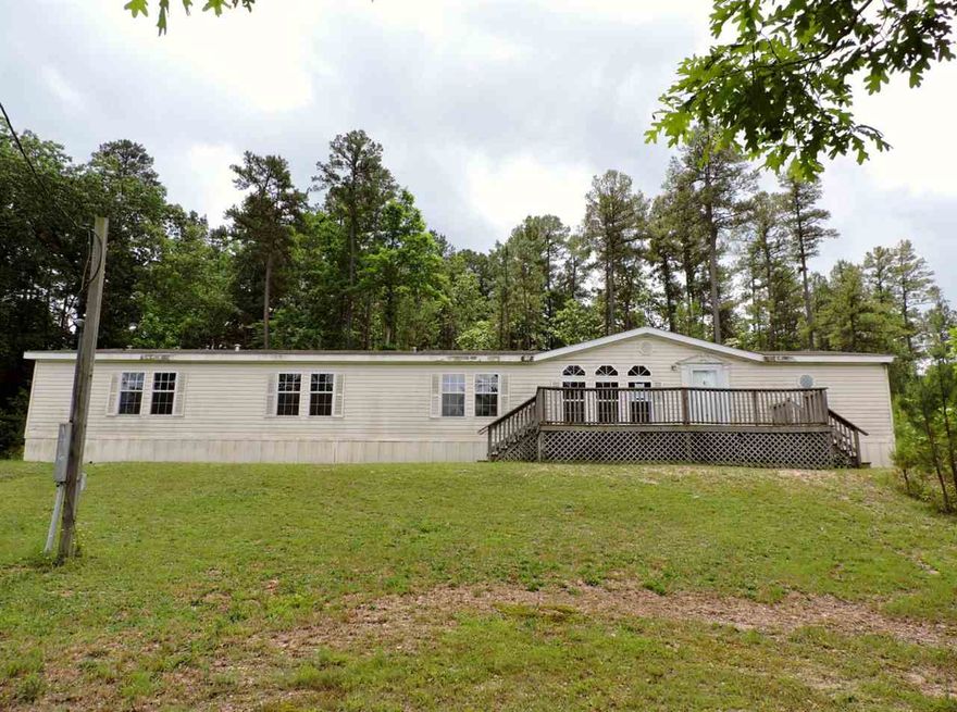 2006 Double Wide Manufactured Home nestled on acreage within the Fountain Lake School District. Home features 4 bedrooms, 3 full bathrooms, central heat, central cool, fireplace and front and side decks. Spacious living room, den with fireplace, kitchen and separate dining room. HUD Case #031-336490, FHA Financing: IE (Insured Escrow), Property is sold in as is condition, no warranties, guarantees or representations about the property.