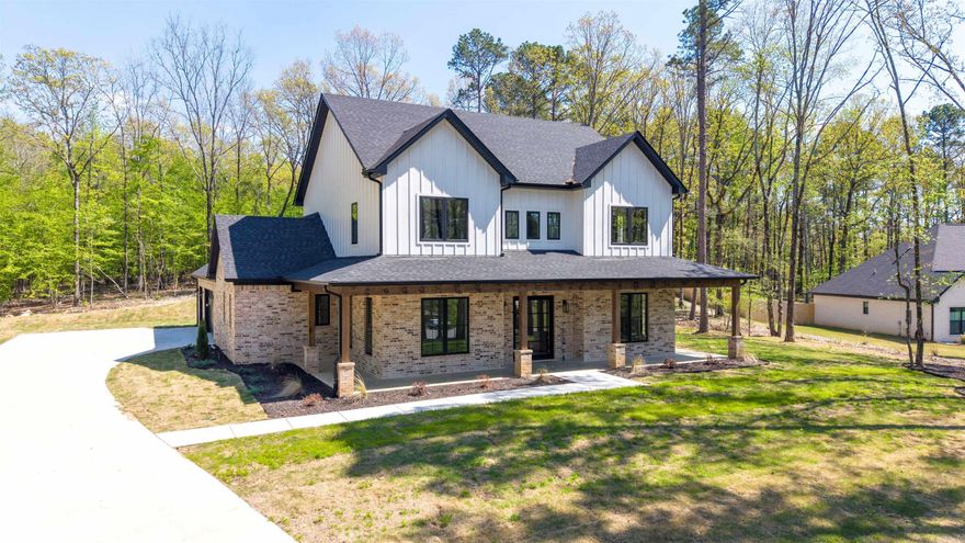 Stunning home! Situated on a wooded, acre-sized lot, this home offers numerous amenities and understated luxury. You are welcomed into a large foyer by a gorgeous iron and glass pivot door. The living room steals the show though, with soaring ceilings, floating shelves, and windows looking out over a large covered patio with an outdoor fireplace. The kitchen is a culinary haven with numerous white oak cabinets, a large island, double ovens, and a dual refrigerator/freezer. The home chef will love the butler AND spacious walk-in pantries. A nearby dining room has numerous windows for natural lighting and built-ins for storing seasonal dishware. The primary suite is fantastic, featuring tiled walls with a large shower and freestanding tub in the bathroom and his/her vanities and a large walk-in closet. An office, secret bonus space, half bathroom, mudroom, and large laundry room round out the main level. Upstairs, there are 3 additional bedrooms, as well as two more bathrooms and large bonus room. Home is wired for surround sound, includes extra storage garage for an ATV/tool room and/or potential exercise room, has an irrigation system for the zoysia sod, and so much more.