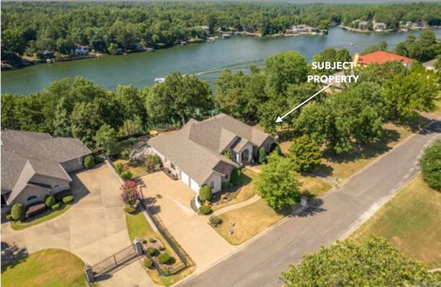 Stunning Lakefront Home. If you love to entertain, this home's casual elegance with expansive chef's kitchen is just for you! Natural light abounds in this spacious home with 2 living areas and 2 kitchens spread out over 6453sf on .66 acre. You can meander at will! Chef's kitchen boasts a SubZero fridge and Dacor dual-fuel oven range with convection oven. Granite counters, custom cabinets, wet bar, wine fridge and a dedicated ice maker are just a few of the finishing touches that will WOW you. Play by the saltwater pool or tram down to the lake for a day of sun and fun on beautiful Lake Hamilton. Covered boat dock on 130 feet of lake frontage. Home has a primary bedroom and a fireplace on each floor. All 4 bedrooms are en suite. Large office can be 5th bedroom with extra room for more beds downstairs as well. Furnishings are optional - so you could move in tomorrow! (Well, almost. ;) New decking throughout, new carpet in all bedrooms and living room, and new roof in 2023.