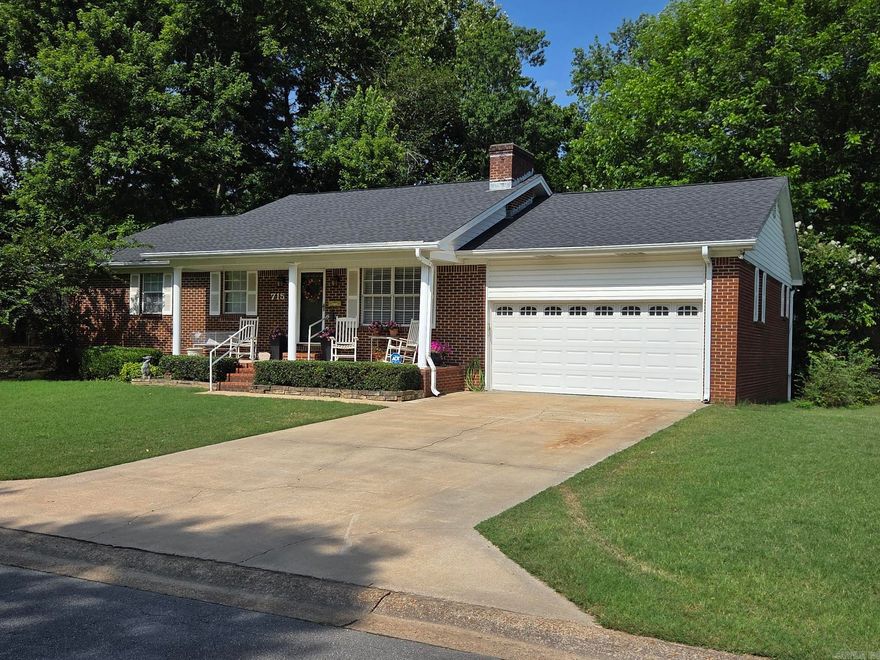 This nice brick home with 2-car garage has it all & is updated. The main floor has 3 bedrooms, 2 updated baths, kitchen with backsplash, pantry, lots of counter space & pull-out drawers in cabinets. The living area features a vaulted ceiling with wood beams, site-built brick fireplace & wood floors. There is also a 12x 30 covered deck for relaxation as well as a similar size patio below at ground level. The walk-out basement has a large den, bedroom & an office that could be used as a 5th bedroom. The bath downstairs is large & the is also a mechanical room/ canning room that can be used as office or more storage & a kitchenette. There are 2 walkout doors in basement & a parking pad in back, so the basement could be used as a separate living area with outside entry. Roof & HVAC are 2 years old.