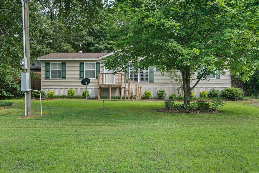 Spacious Country Living with Modern Comforts! This beautifully maintained 3-bedroom, 2-bath manufactured home sits on just under an acre of land, offering the perfect blend of space, comfort, and convenience. You’ll love the open concept layout, featuring a very large kitchen ideal for cooking and entertaining, complete with ample cabinetry and workspace. The inviting rock fireplace serves as a stunning centerpiece in the living area, while plantation shutters add a touch of Southern charm throughout.  Enjoy the privacy and freedom of a larger lot, along with a shop—perfect for hobbies, storage, or workspace. The location is truly unbeatable, providing peaceful surroundings with easy access to nearby amenities. If you’re looking for space, style, and a move-in-ready home with character, this is the one!