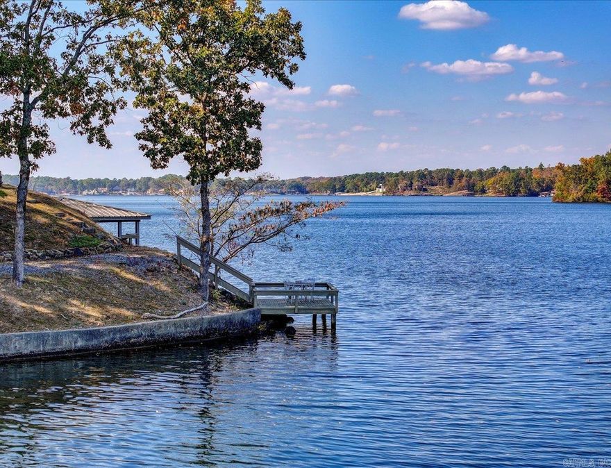 STUNNING PRIME LOCATION Lake Hamilton home and dock with 300 feet of frontage in Lakeside School District.  Two primary suites! Could make a great STR!  The 5 bed, 4 bath, 3800 sq ft home has ample space for your family to comfortably enjoy lake living and still has space for you to host friends and family for wonderful memorable entertaining.  The current owner has been carefully updating the home with a timeless look and feel that'll still be in style for years to come. There's new luxury vinyl flooring and fresh paint. A completely remodeled kitchen with a raised roof, Cafe appliances, sonic ice machine, and granite countertops. Move right in and live luxuriously.     With an enormous primary suite and attached copper decked balcony overlooking the lake you can give yourself resort like experience everyday.  This gorgeous home has nearly impossible to match lake frontage with spectacular lake views on a private point in a cove off of the main channel. It has year round water and is 40 ft deep.   It'll be a treasure for years to come. Must see!!   Agents - Call Showing service to schedule all showings.