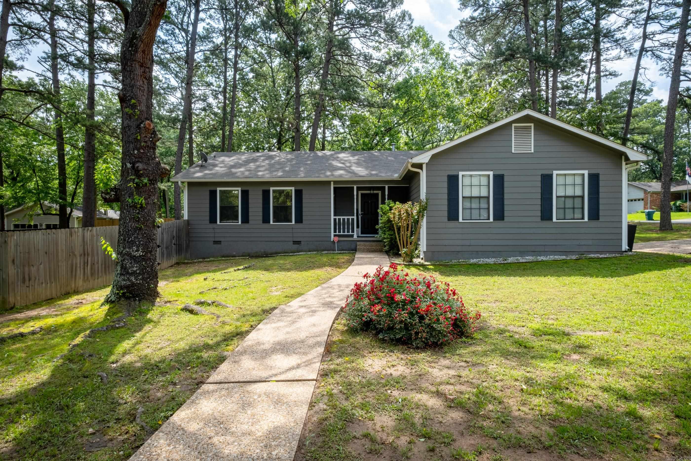 Welcome home to this absolutely adorable, completely remodeled, home in a highly sought after area of West Little Rock, Situated on a corner lot in a quiet cul de sac street. Relax and enjoy the large backyard from the covered deck complete with bluetooth speakers set just off the kitchen in a private setting protected by a new wooden privacy fence. There is all new Luxury Vinyl flooring throughout the entire house, new lighting, fresh paint, new kitchen and bathroom counters, new hardware, and some new cabinets as well. Enter in from the front porch into the spacious living room with vaulted ceilings and a wood burning fireplace. Open to the kitchen you will find stainless appliances, new countertops, new lighting/ flooring, and a farmhouse sink. There is a separate laundry room off the kitchen. In the primary suite you will enjoy the privacy and convenience of an ensuite with a nice walk in closet, new shower, sink and countertops. Make this rare gem yours today!