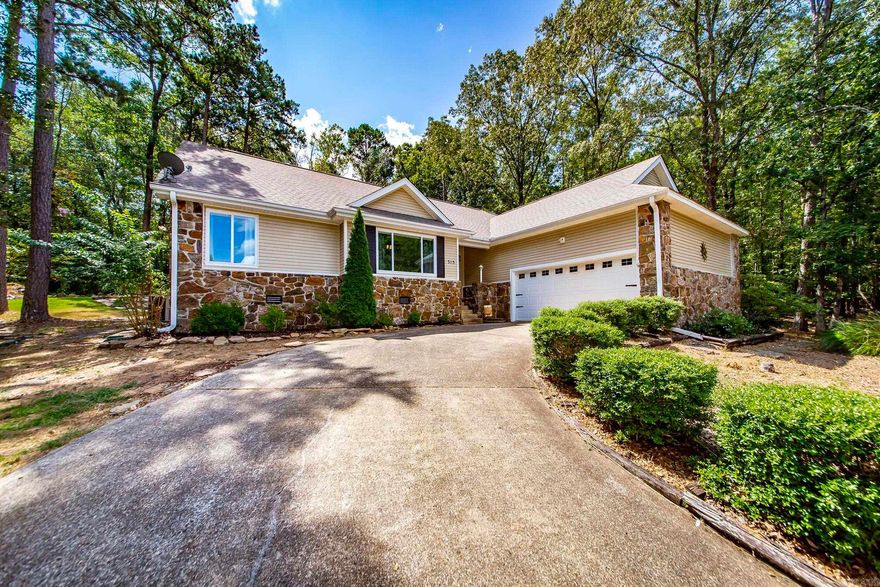 Golf Course Frontage on all 4 lots that also provide plenty of privacy with buffer lots on both sides of the home!  Sellers are moving back to their hometown in North Carolina to be closer to family. These have been replatted into one large tract with 1.03 acres & only one set of dues which is $218.85 per month which includes insurance on the city sewer grinder pump, tennis courts, pickle ball courts, 3 swimming pools (Mountain Ranch, Cool Pool, & Hamilton Cove Pool), ATV Trails, Hiking & Biking Trails, Playground, & Picnic Pavillion. This home has new flooring, new paint, Primary Bathroom has been completely remodeled with river stone flooring, new jacuzzi tub, walk in shower, new vanity & reconfigured walk in closet. Sellers have had licensed contractor do some extensive work on the drainage flow in the backyard & on the sides of the home so new french drains etc. plus new back deck,extended patio, outdoor lighting in the trees, & property backs right up to hole 18 of the Mountain Ranch Golf Course. Oversized garage for two vehicles with a nice size storage room with Stand up Freezer that will stay.  Washer, Dryer, Refrigerator, microwave, dishwasher, & oven all stay too.