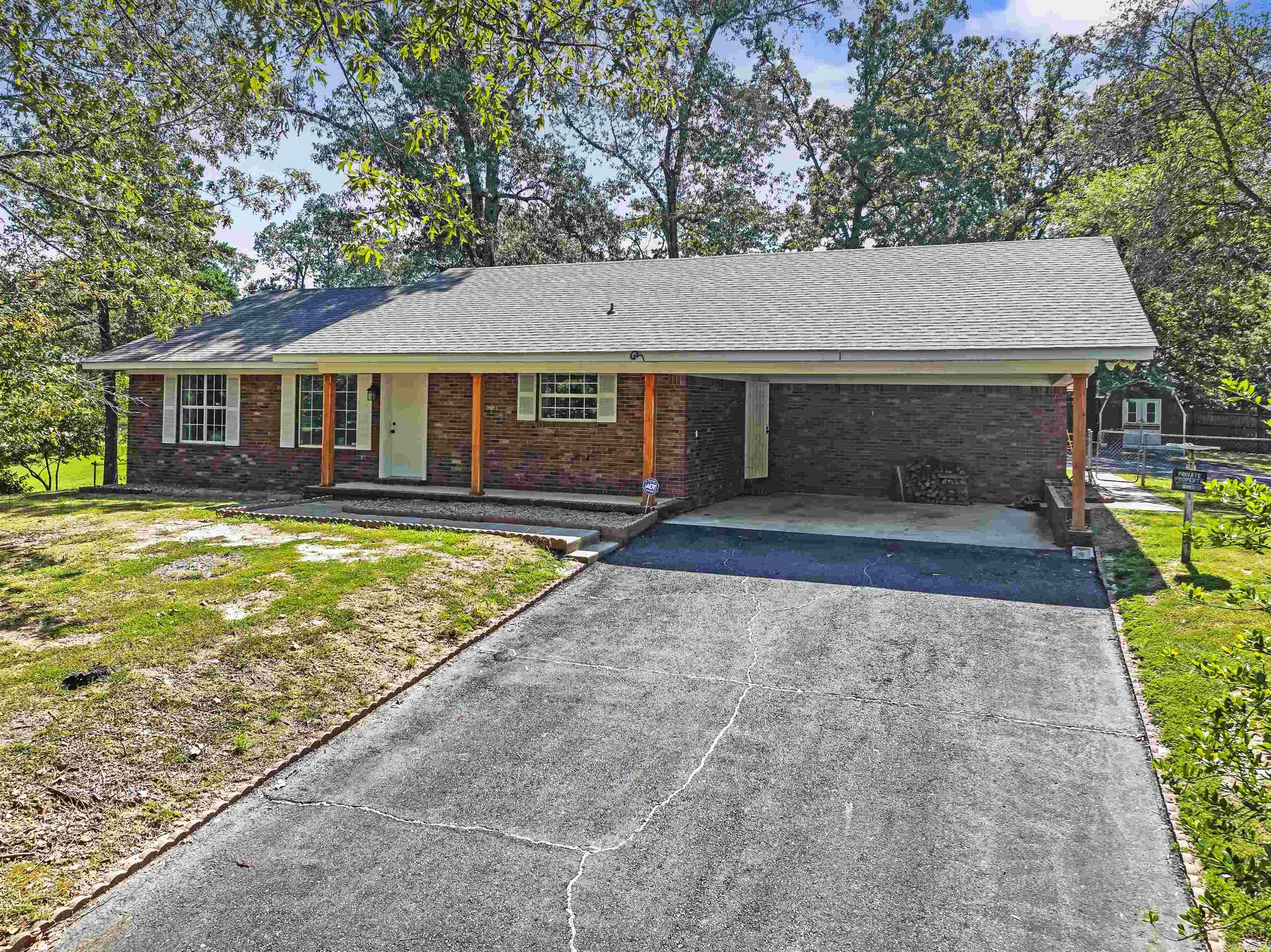 Great family, retirement, or vacation rental property in Hot Springs within 4 minutes of Oaklawn Racetrack and close to schools, shopping, hospitals, dining, tourist attractions, etc. This immaculate brick/vinyl home includes 3 bedrooms, 2 baths with a formal living room and a separate family living areas, newer flooring, granite counter tops, stainless still appliances, roof, and toilets. Home with sun room is nestled on a small hill with one car carport, separate metal garage, additional outbuilding, two paved drives, and so much more. Don't wait long to see this one.