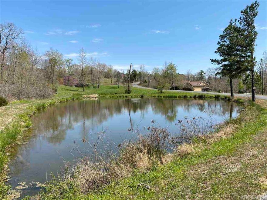 Welcome to the perfect spot for your dream home on this nearly 5-acre lot in Lake Hamilton School District. Choose hilltop with beautiful vista views for your site-built home (no mobile homes permitted),or overlook the large pond for an on-the-water feel. It's so peaceful and serene. Electricity on the property. Permits already on file and located for septic and well locations determined. .  Don't miss this incredible opportunity to turn your vision into reality and create a home where every day feels like a getaway!
